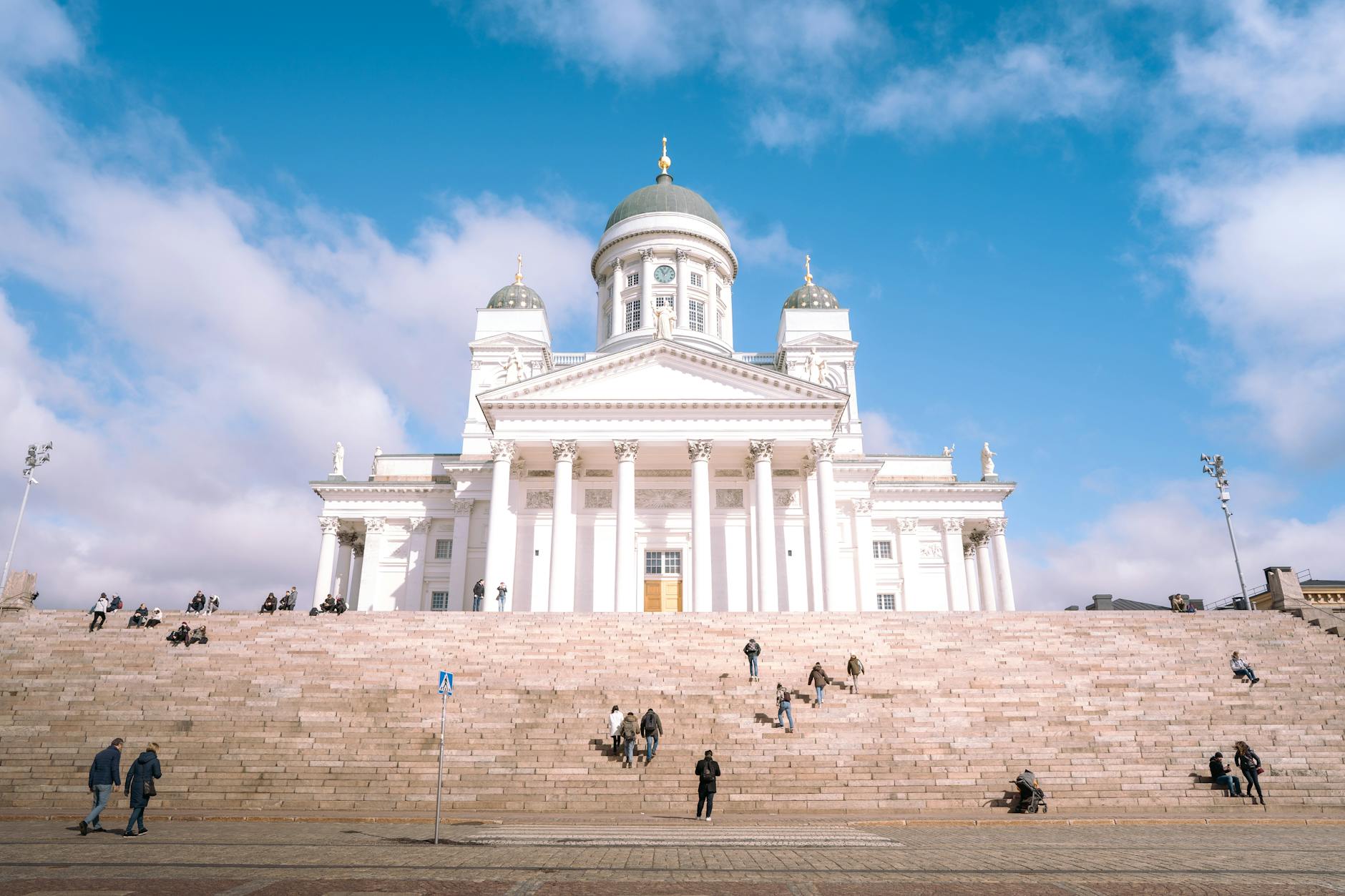 People on Helsinki Cathedral steps for volunteer traveler planning.