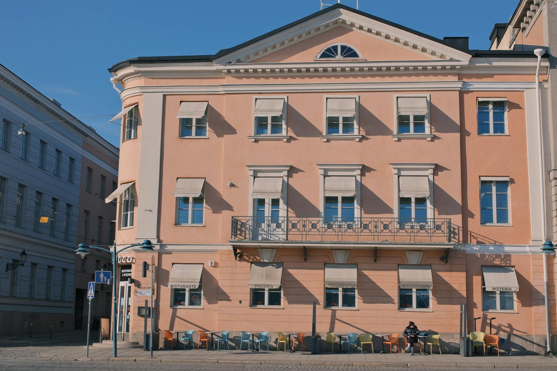 Pink Helsinki building facade for woman traveler lodging planning.