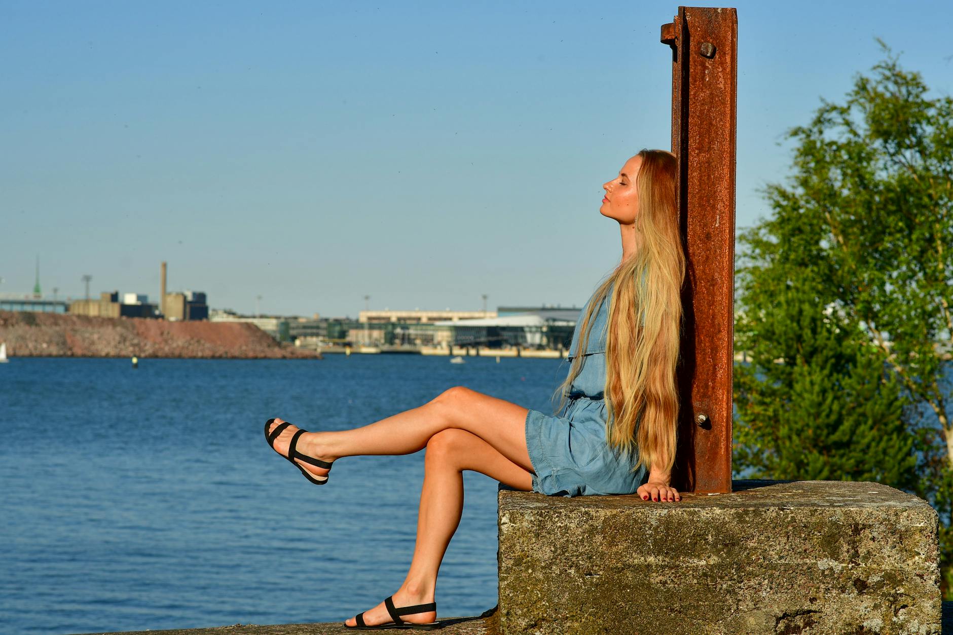 Woman relaxing by the Helsinki waterfront for woman traveler planning.