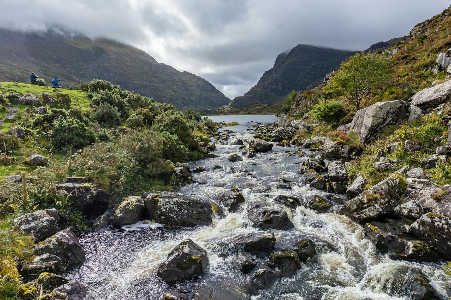 Scenic view of a river flowing through rugged landscapes in County Kerry, Ireland.
