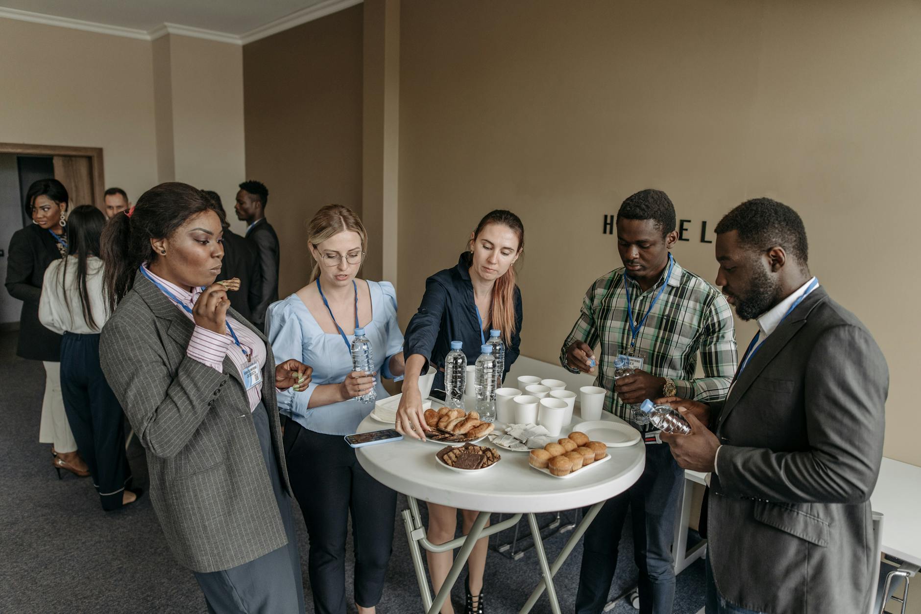 Prominent business professionals networking and enjoying refreshments at a conference.
