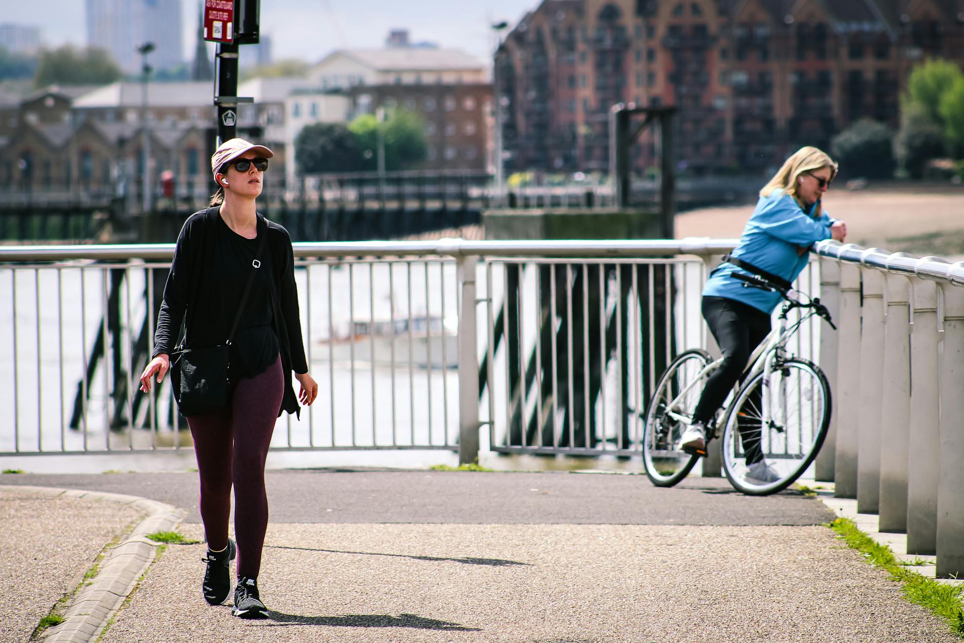 People sitting by the Thames riverside in London