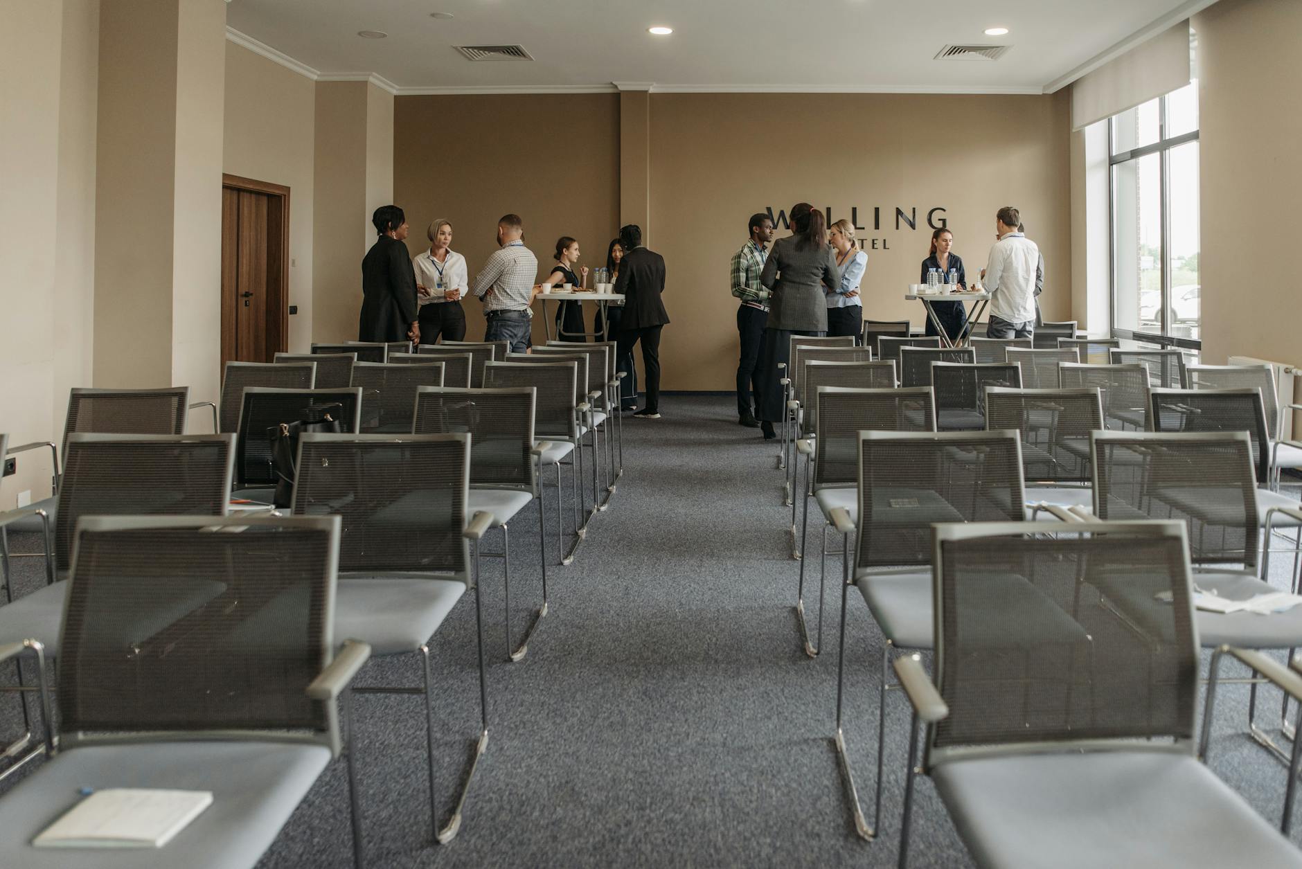 Business professionals networking during a conference break