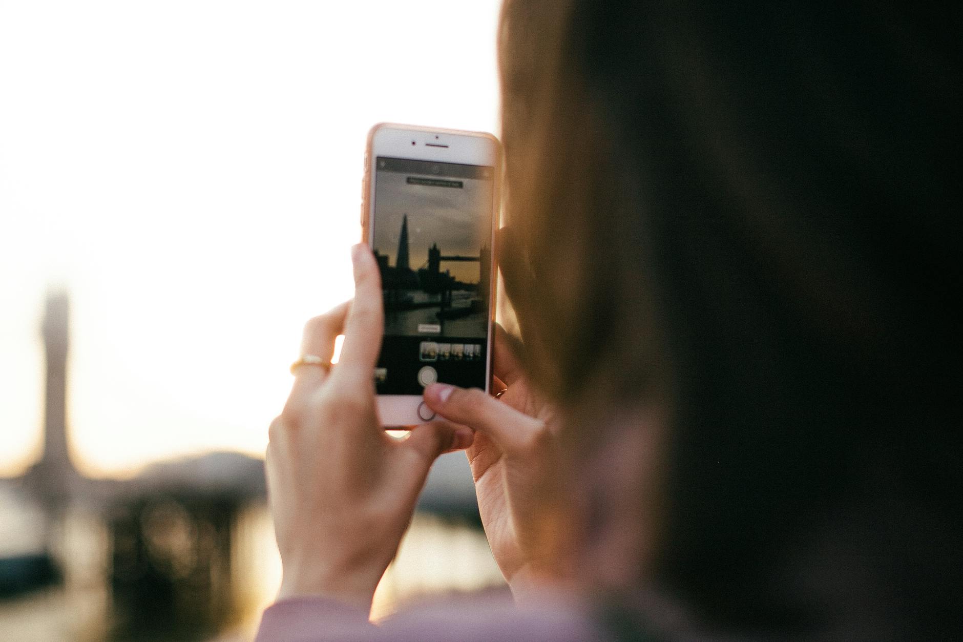 Creator photographing the London skyline with a smartphone
