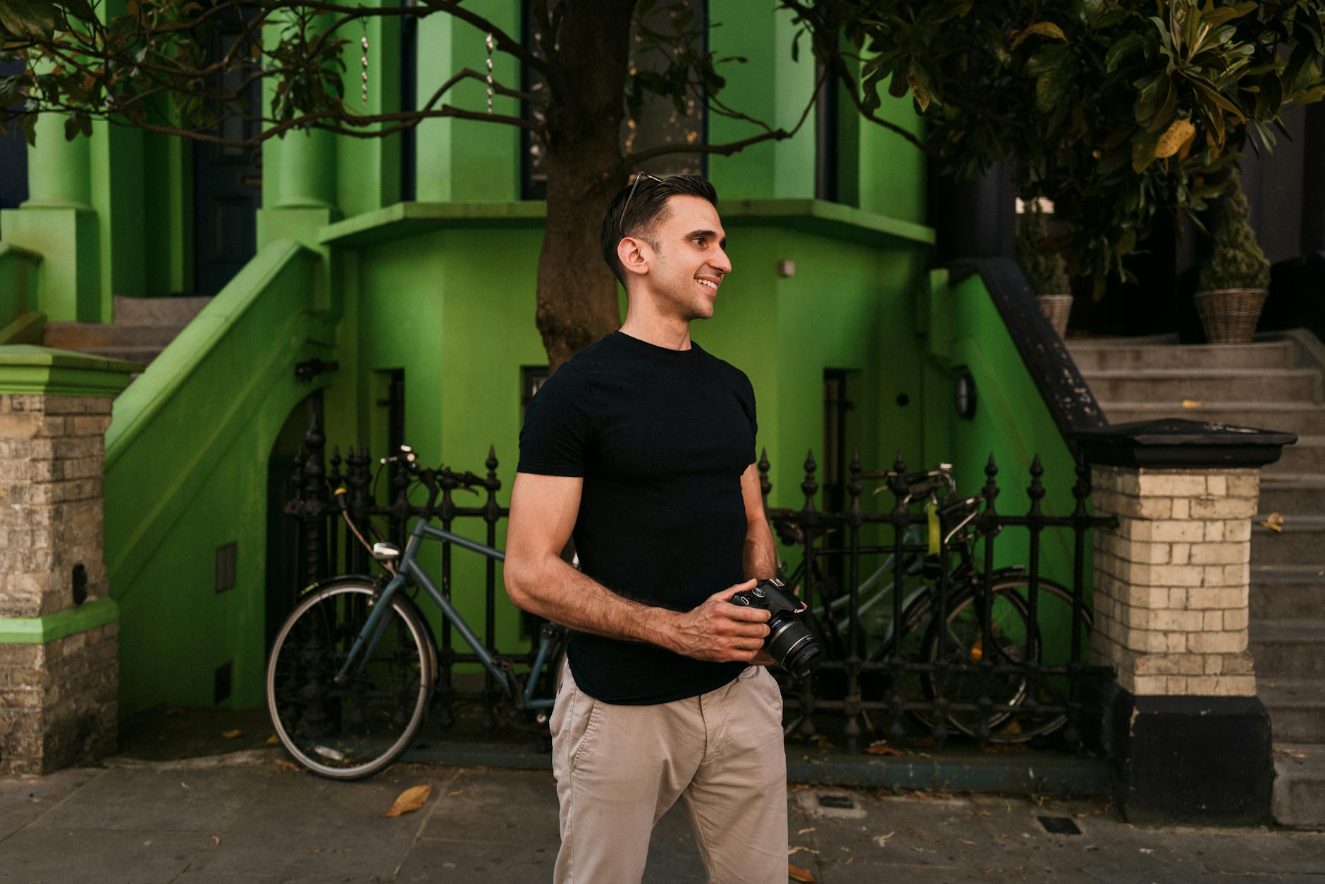Creator with camera on a colorful London street