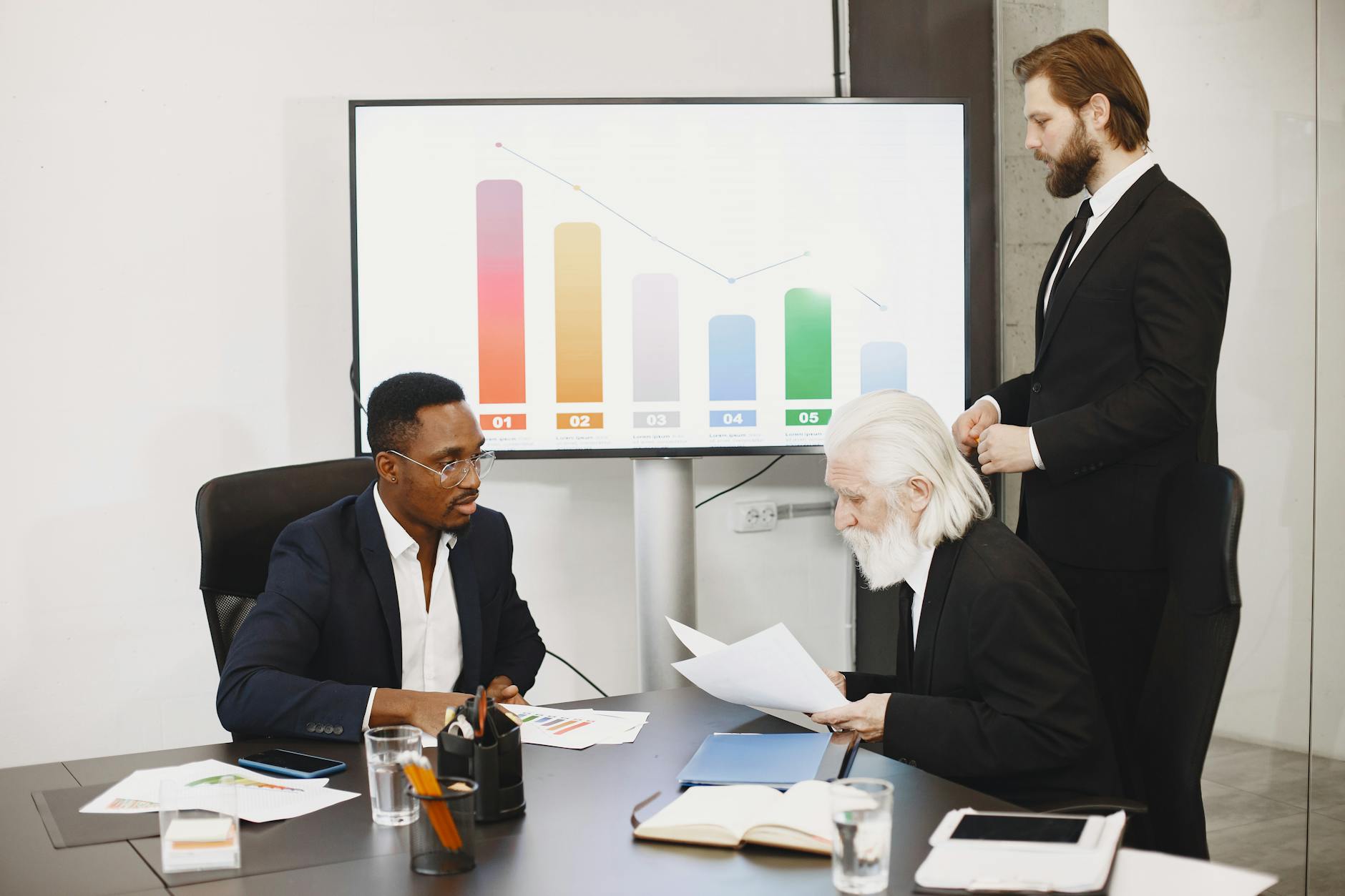Businessmen discussing financial charts in a meeting