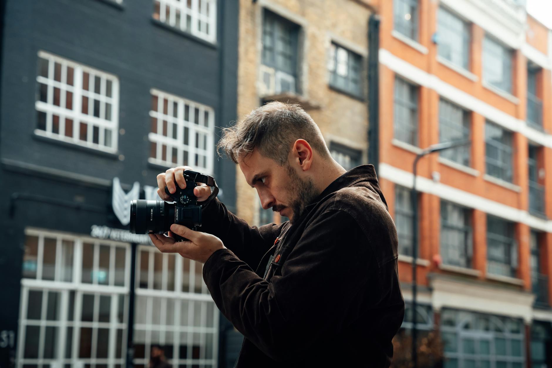 Photographer capturing an urban street scene in London