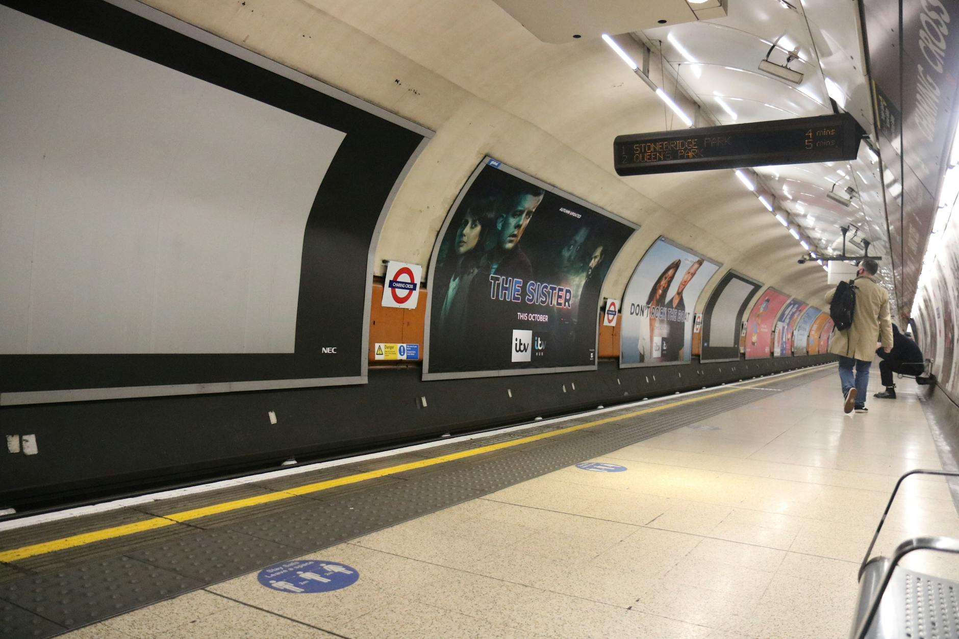 London Underground platform at Charing Cross with waiting passengers