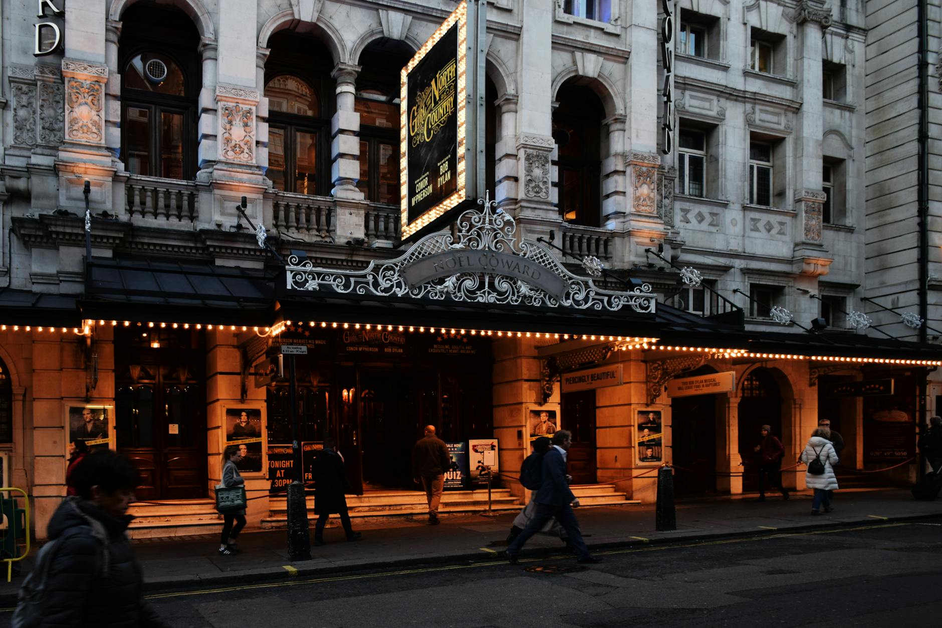 Illuminated central London theater district at night