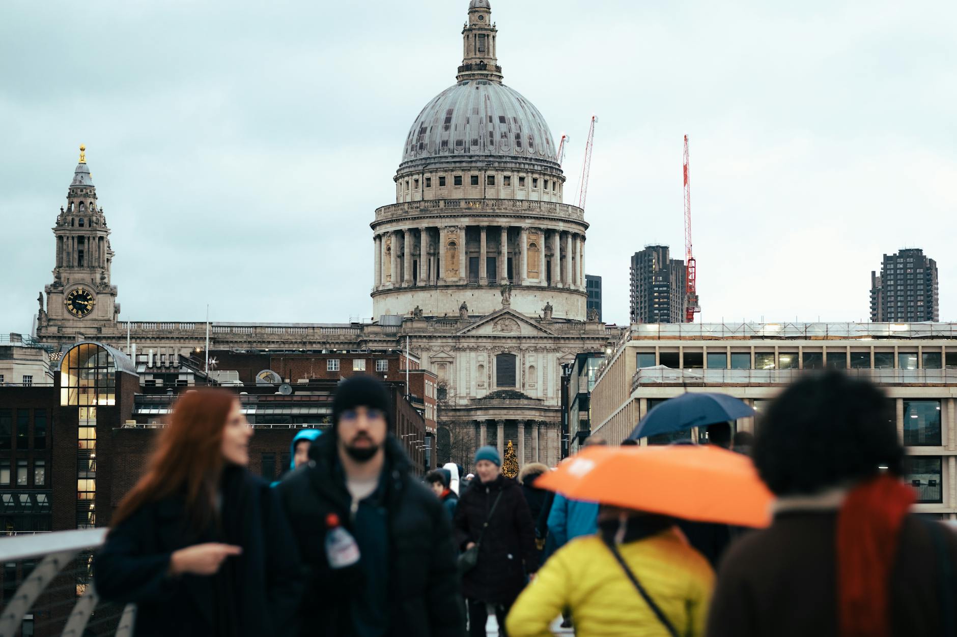 People walking near St Paul's Cathedral and Millennium Bridge in London