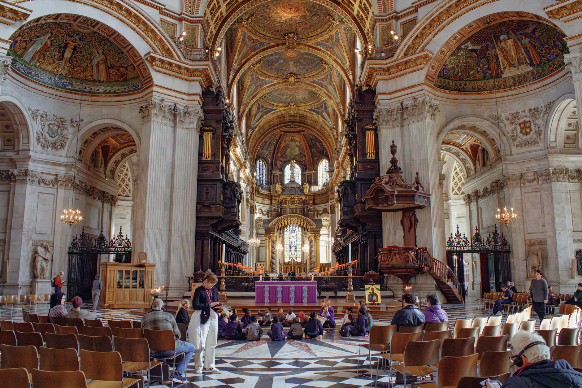People seated inside St Paul's Cathedral in London