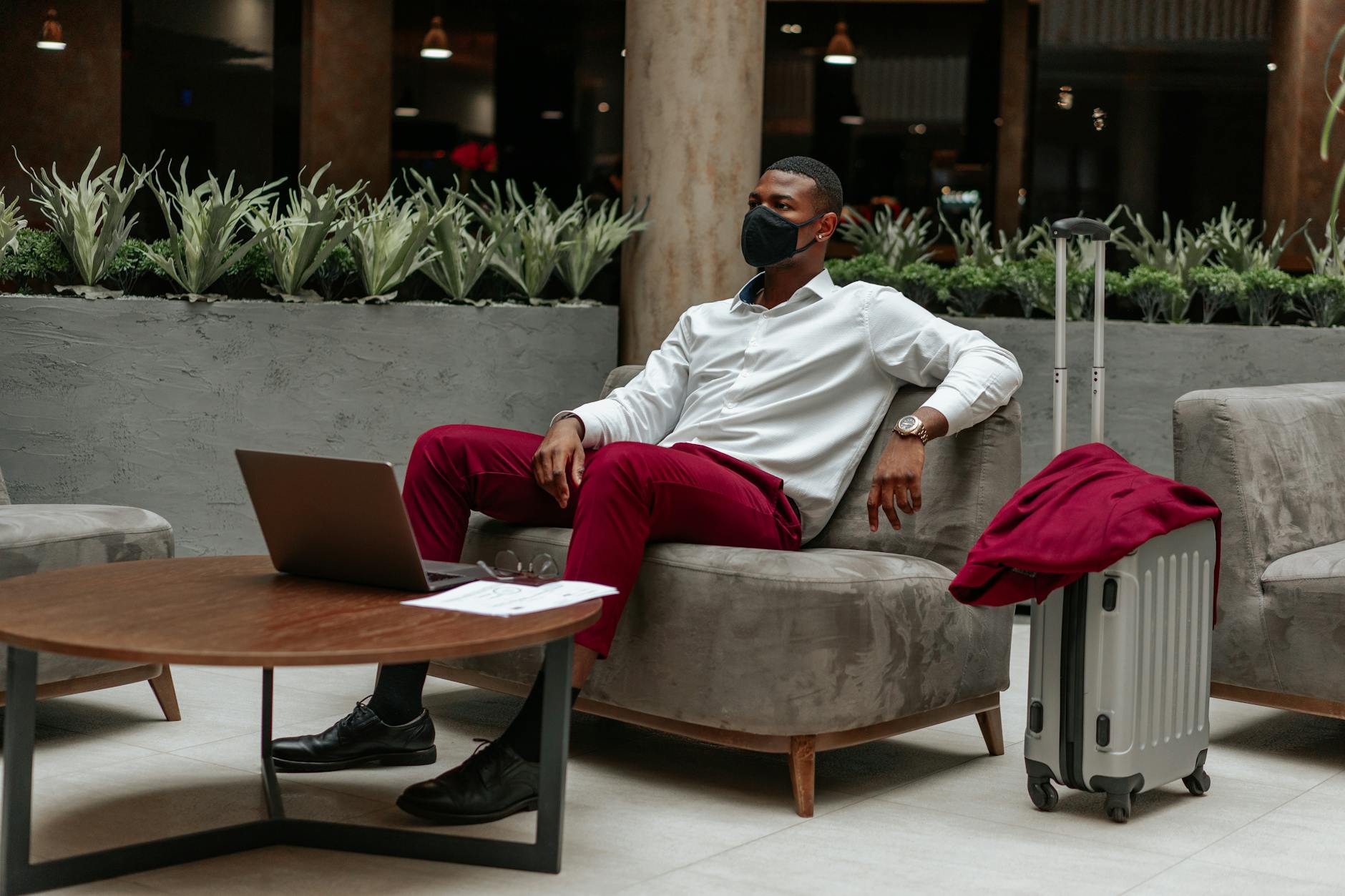 Business traveler working from a hotel lobby with luggage