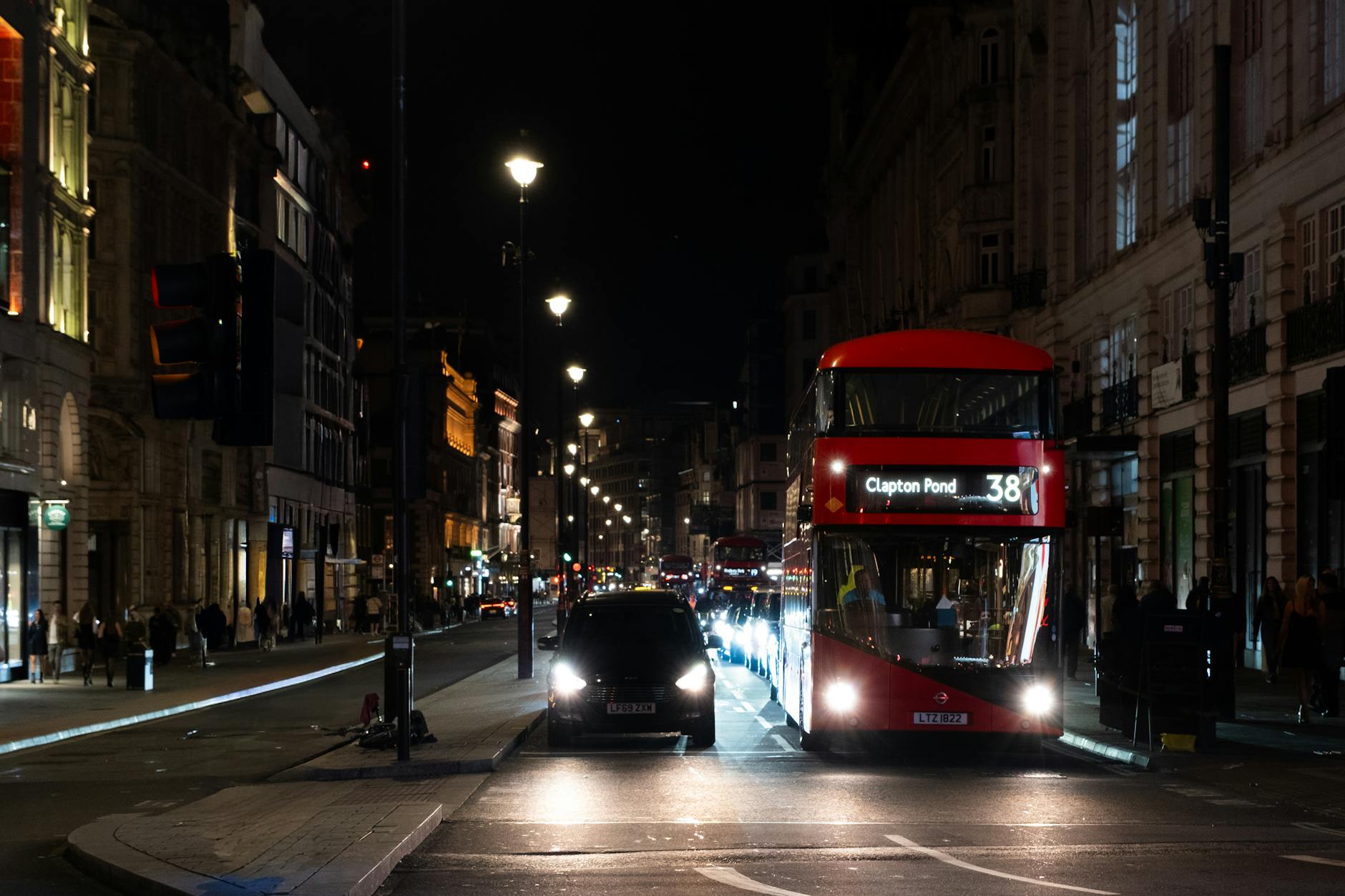 London night street with double-decker bus and bright city lights