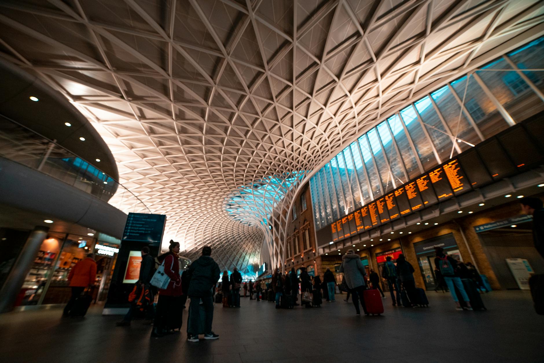 Travelers with luggage inside King's Cross Station