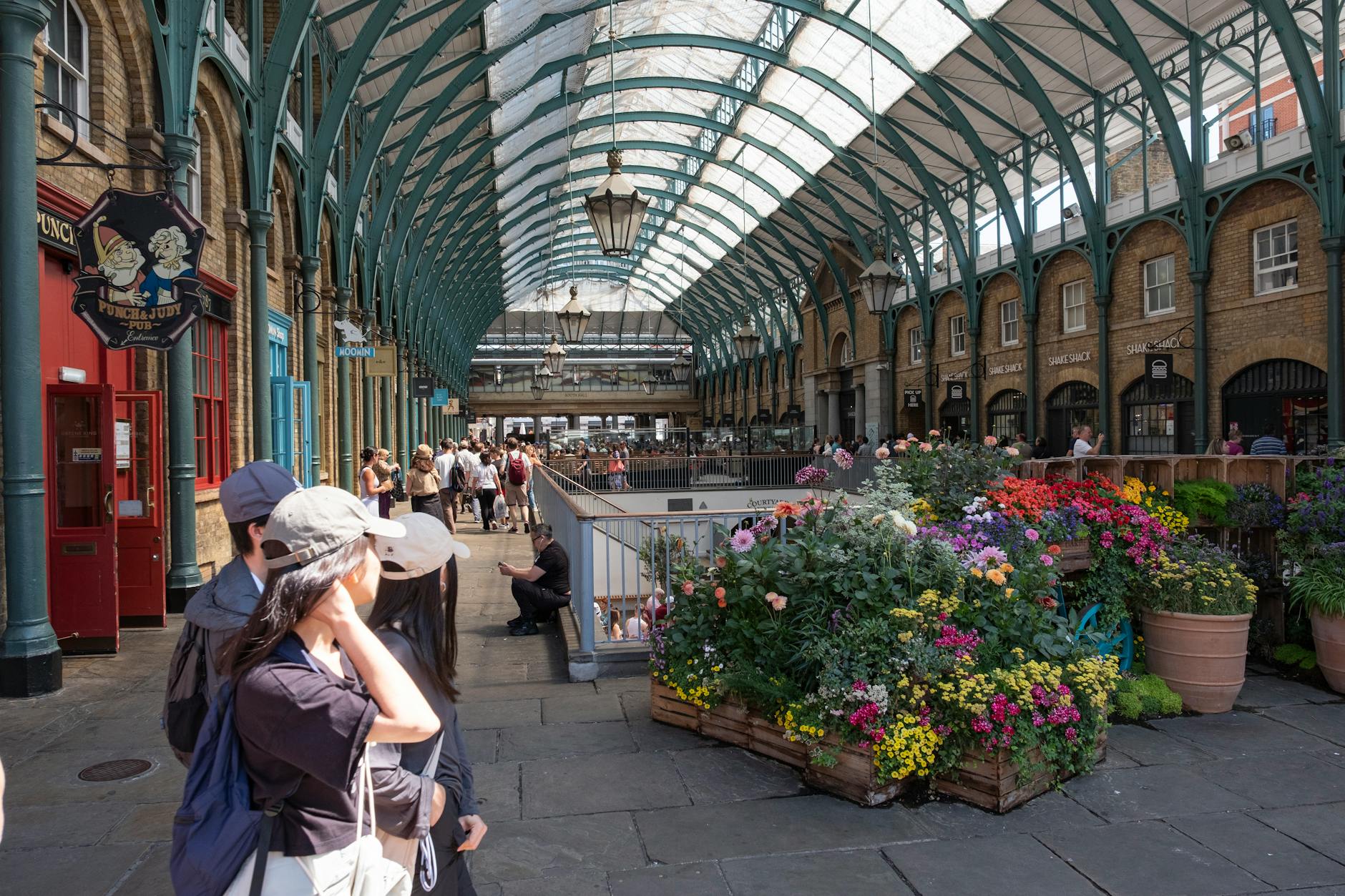 Covent Garden Market with flowers, tourists, and London street life
