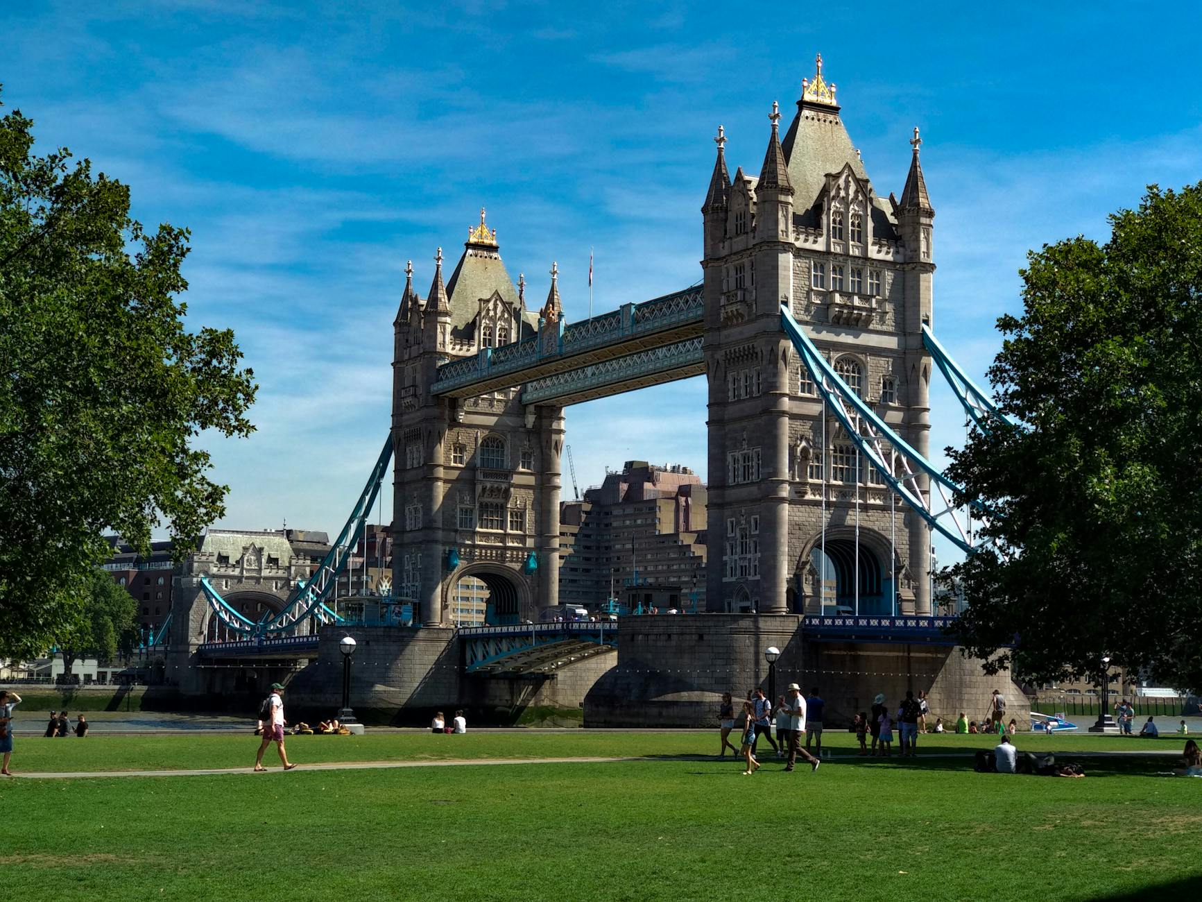 Tower Bridge with tourists and pedestrians on a sunny London day