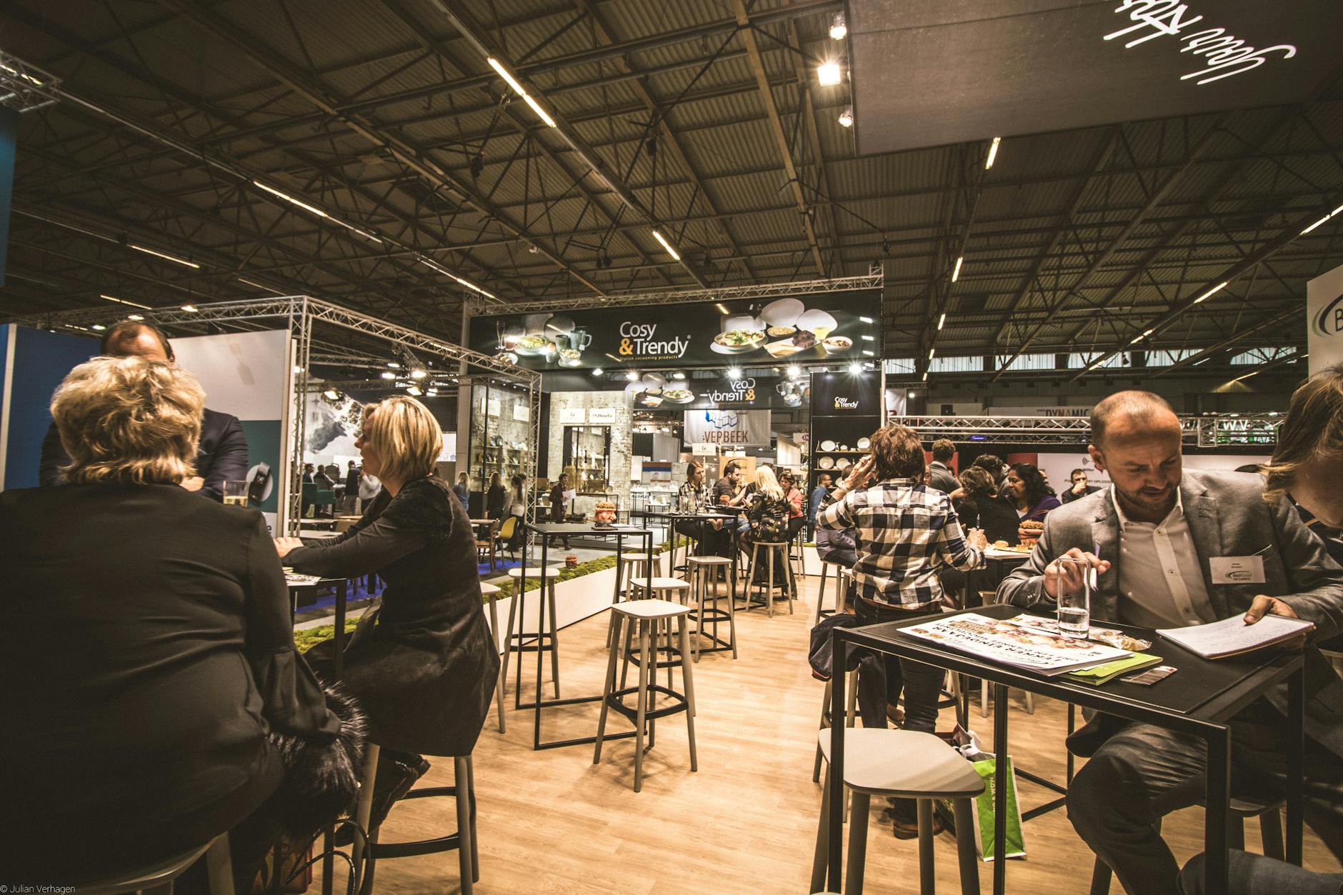 Business expo booths with professionals networking