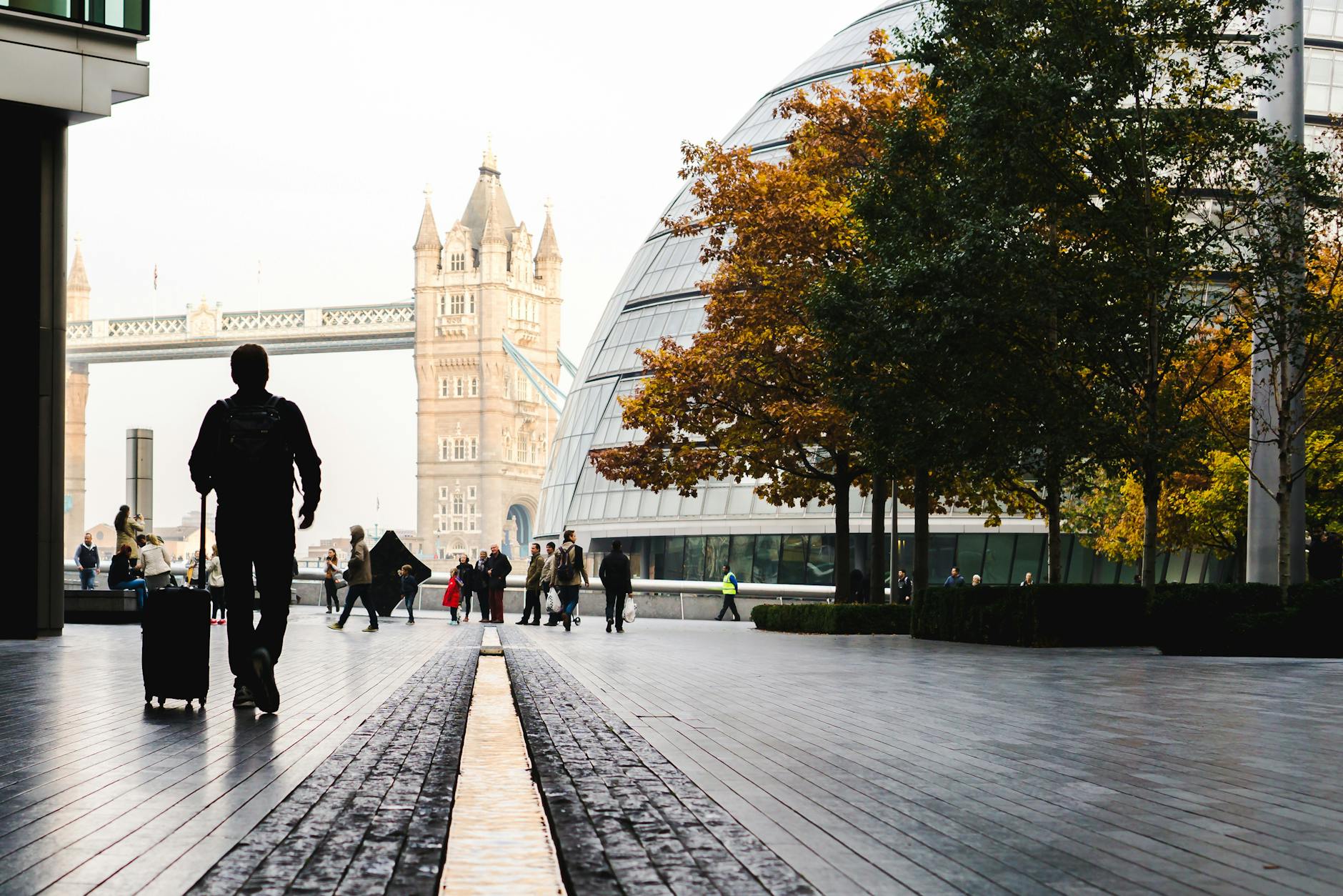 Traveler with luggage near Tower Bridge in London