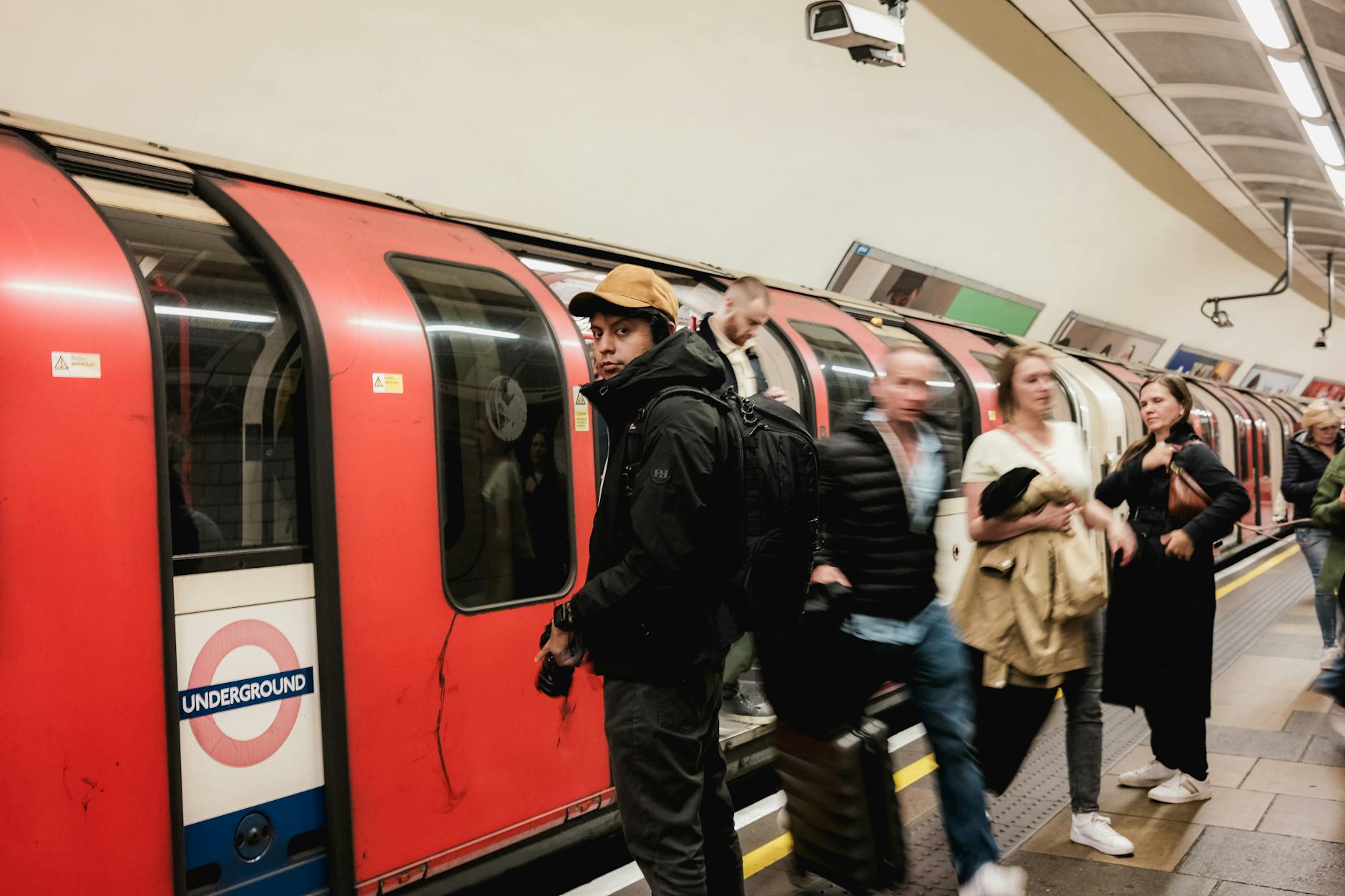 People moving through a busy London Underground platform