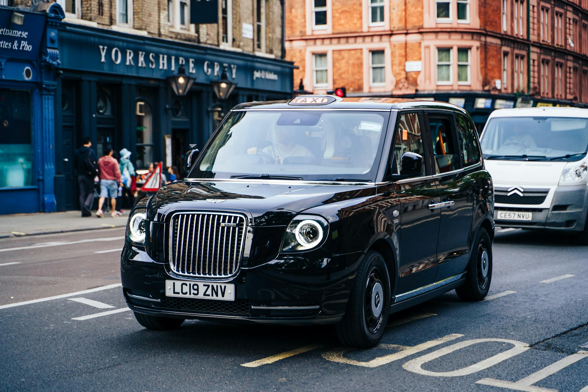 London black taxi driving through the city