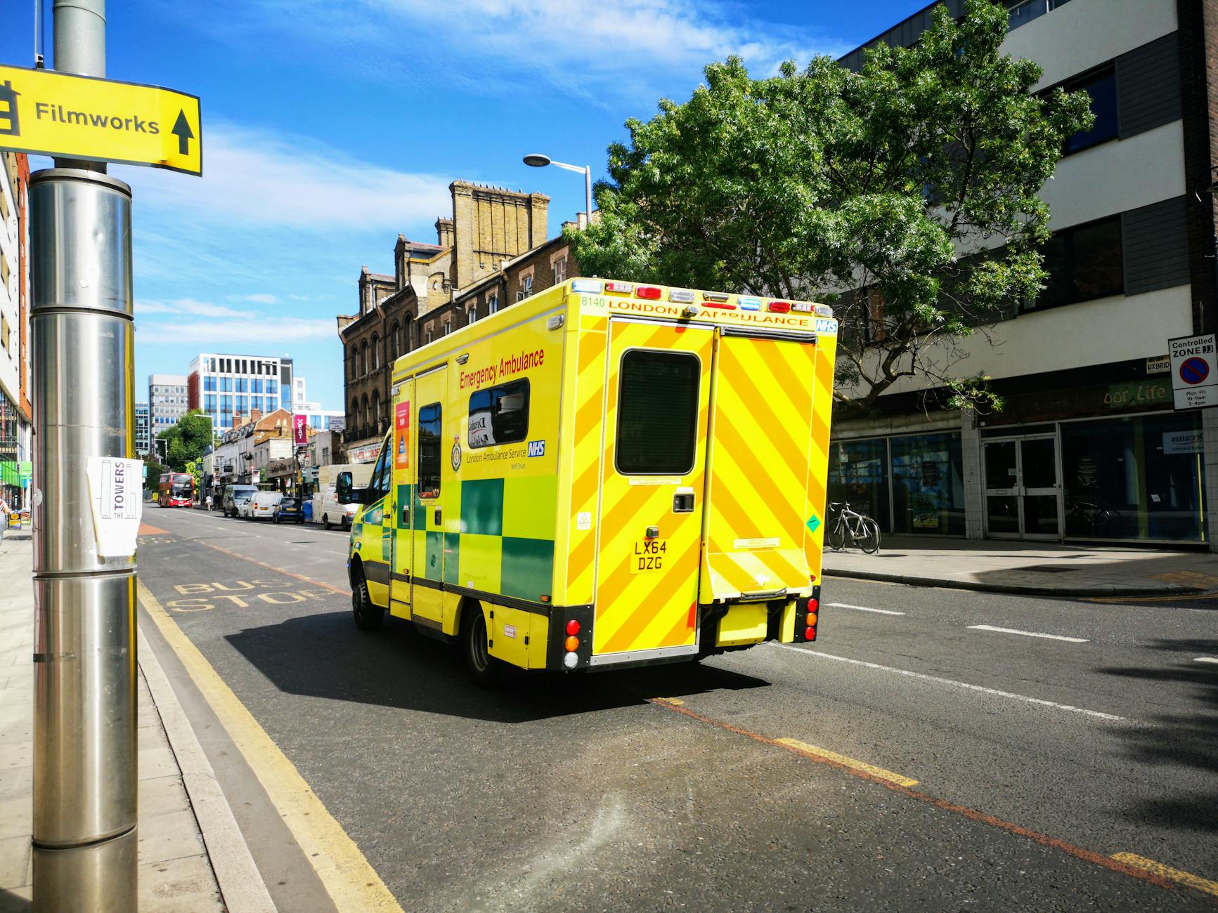 London emergency ambulance moving through a city street