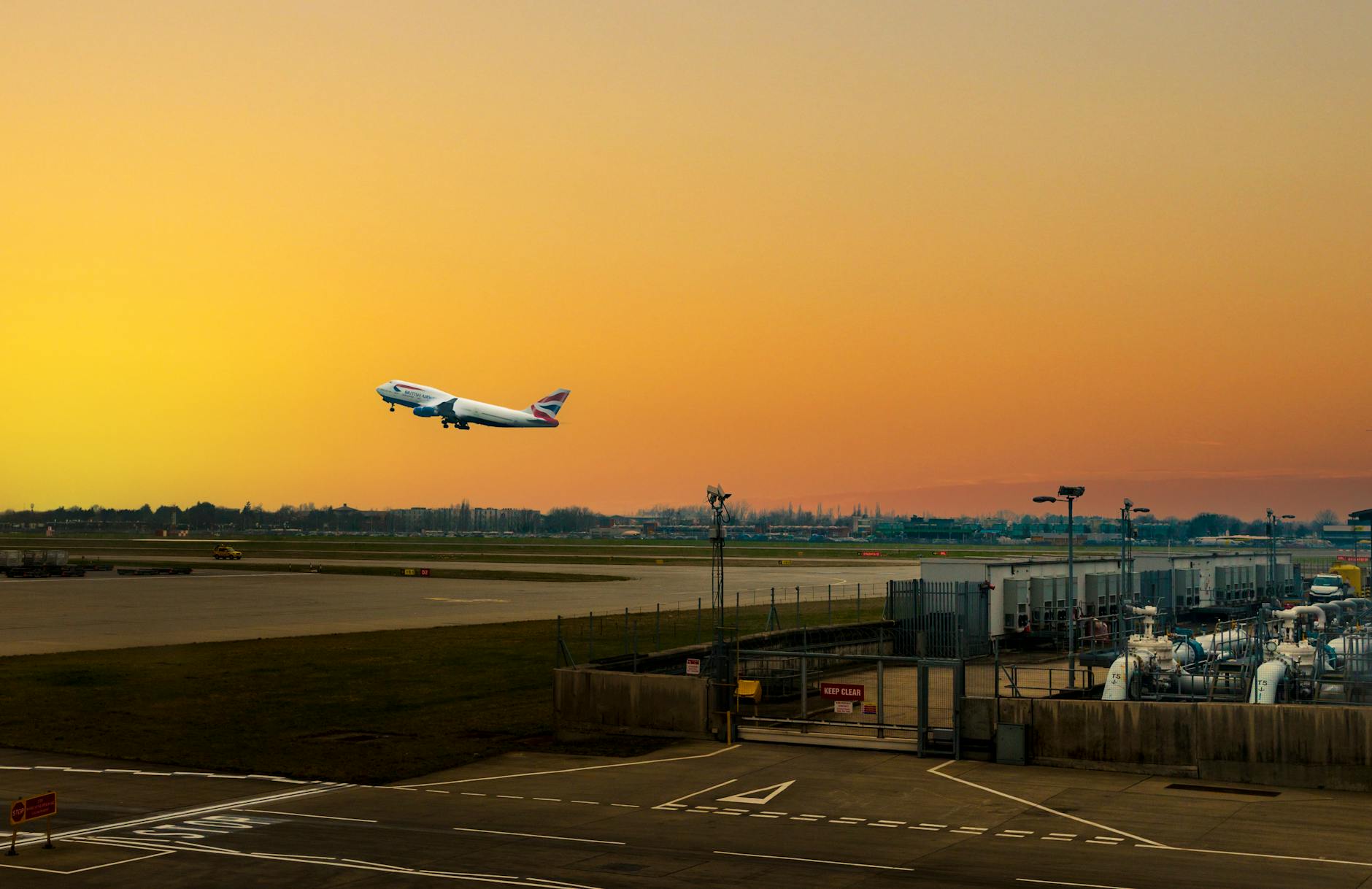 Aircraft departing Heathrow Airport at sunset