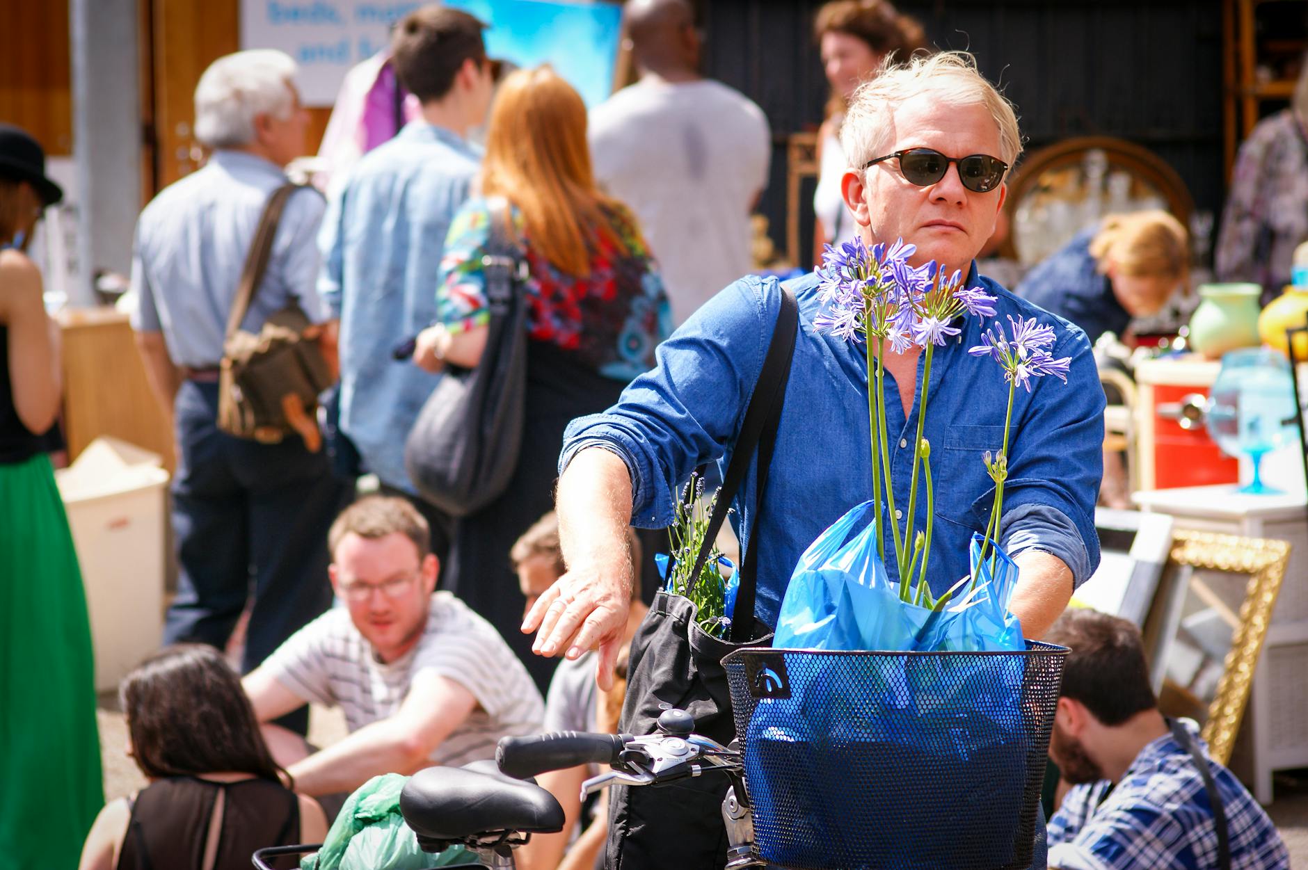 Lively London outdoor market with bicycle and flowers