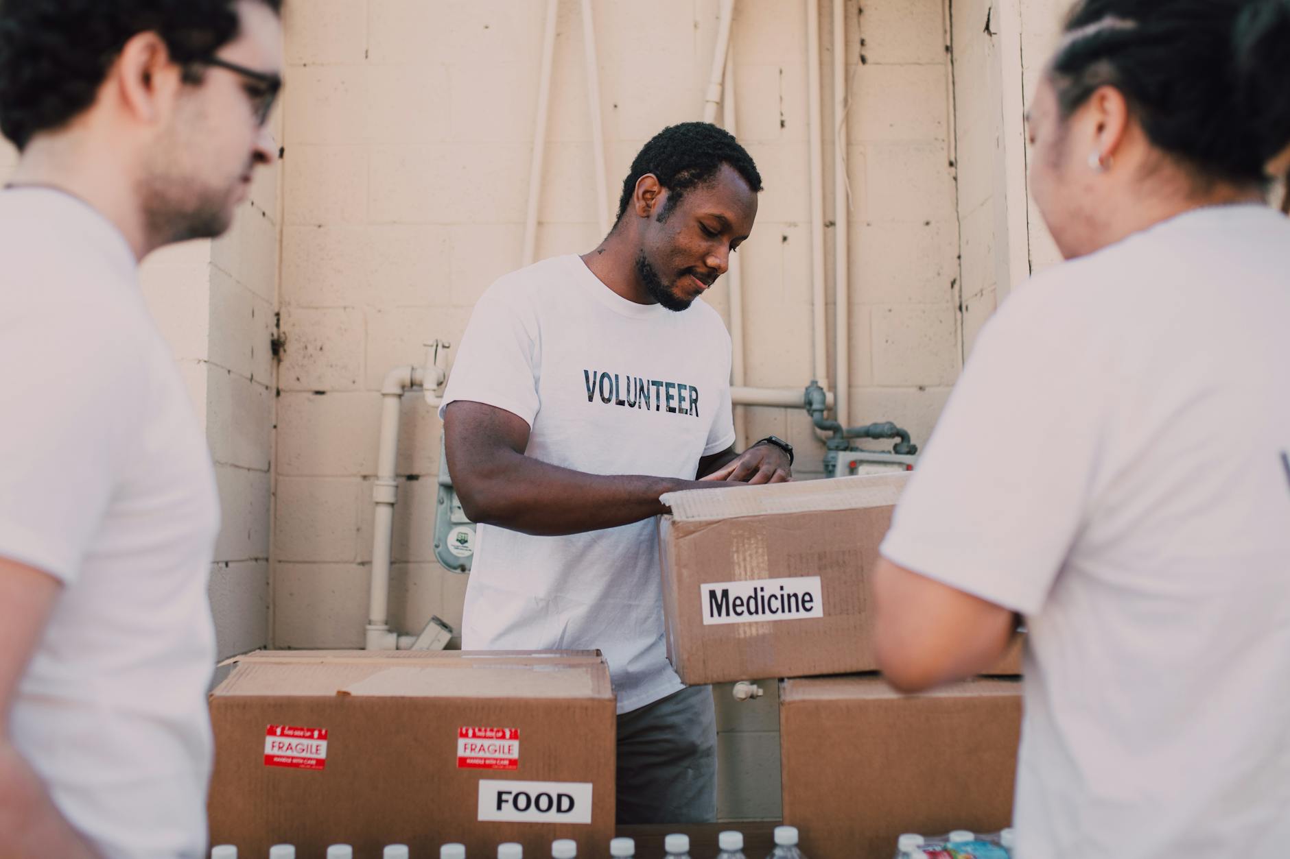 Volunteers packing food and medicine boxes for donation