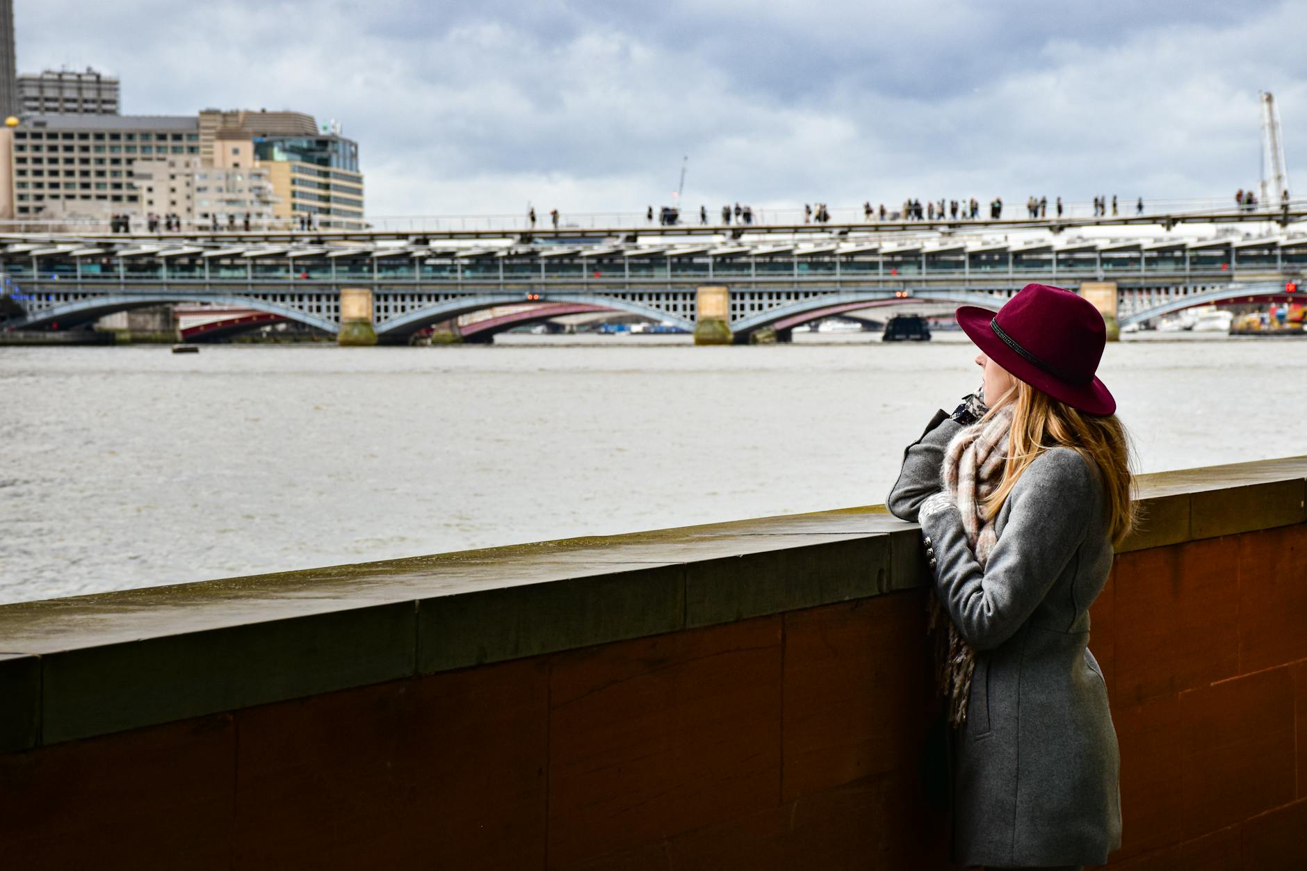 Woman looking over the London riverside near Waterloo Bridge