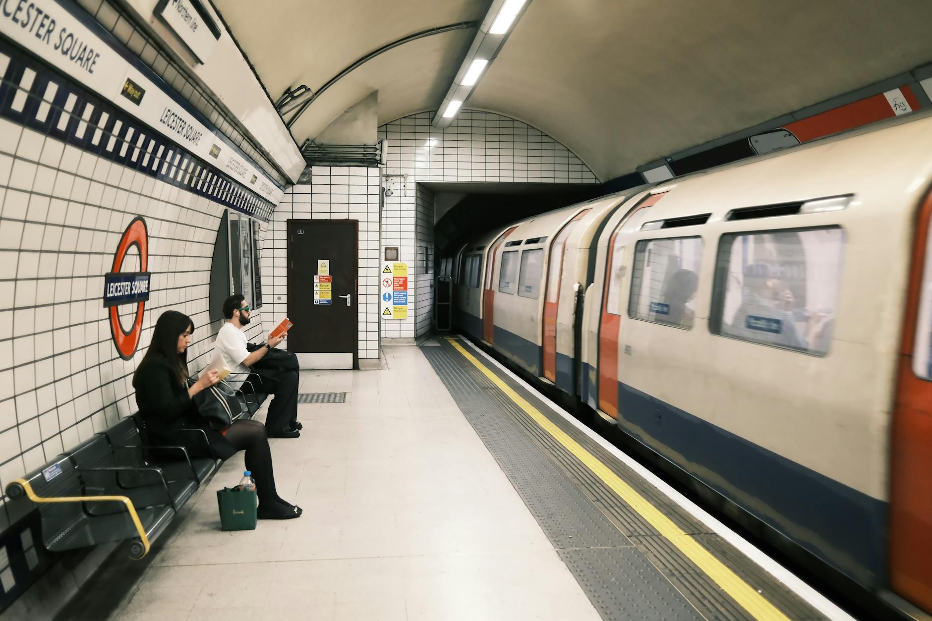 Commuters waiting at Leicester Square Underground station