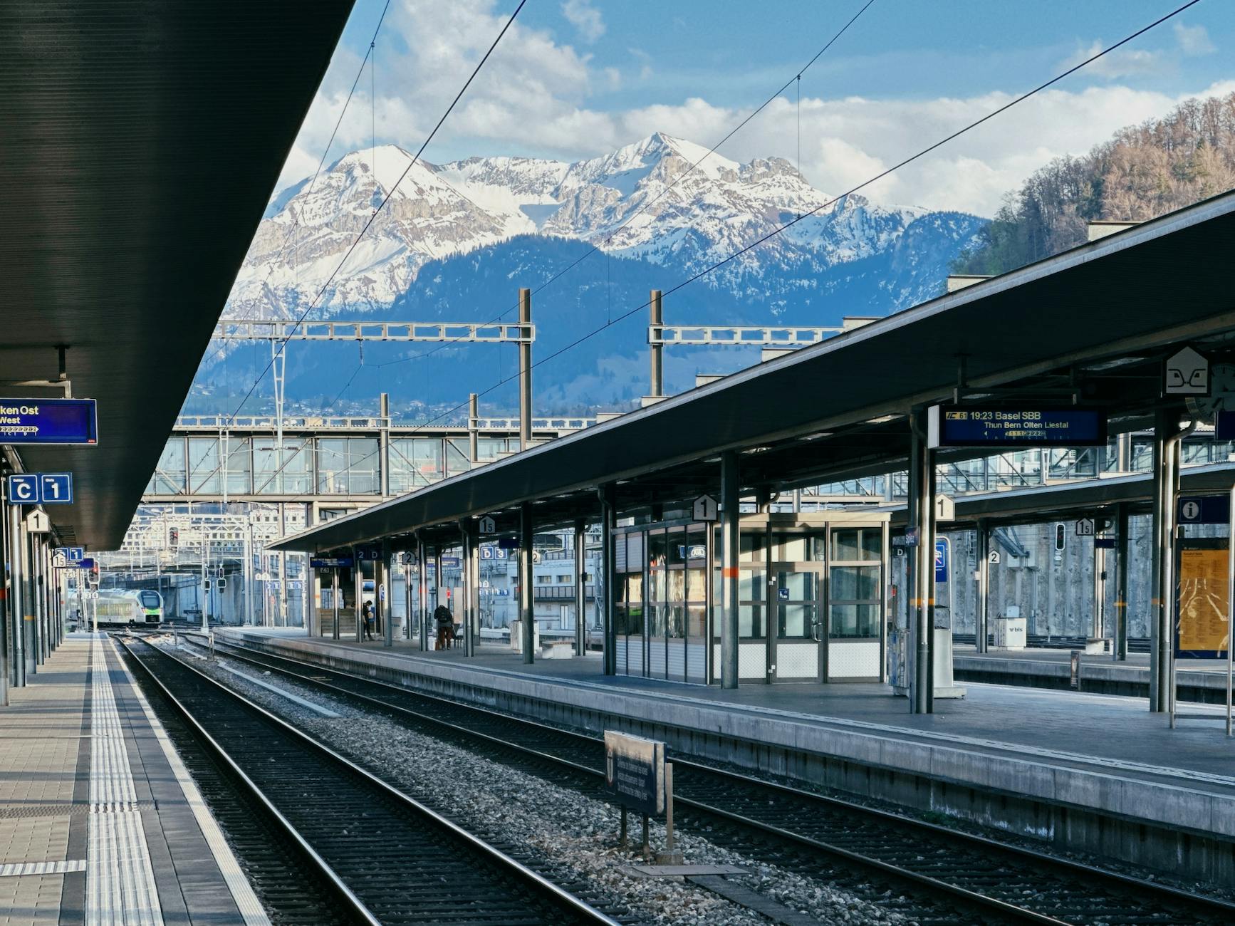 Swiss train station with Alps for Lucerne budget transport planning.