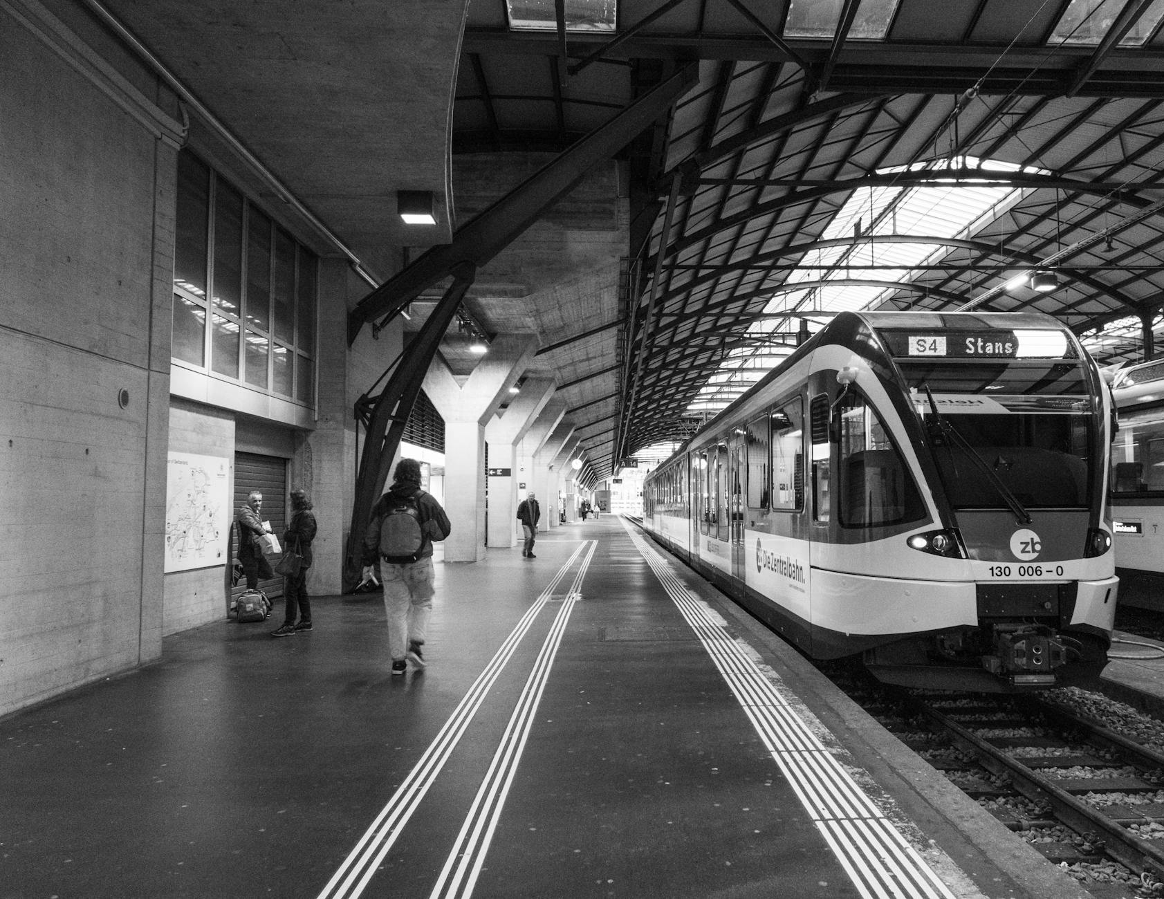 Train platform at Lucerne station context for business meeting logistics.
