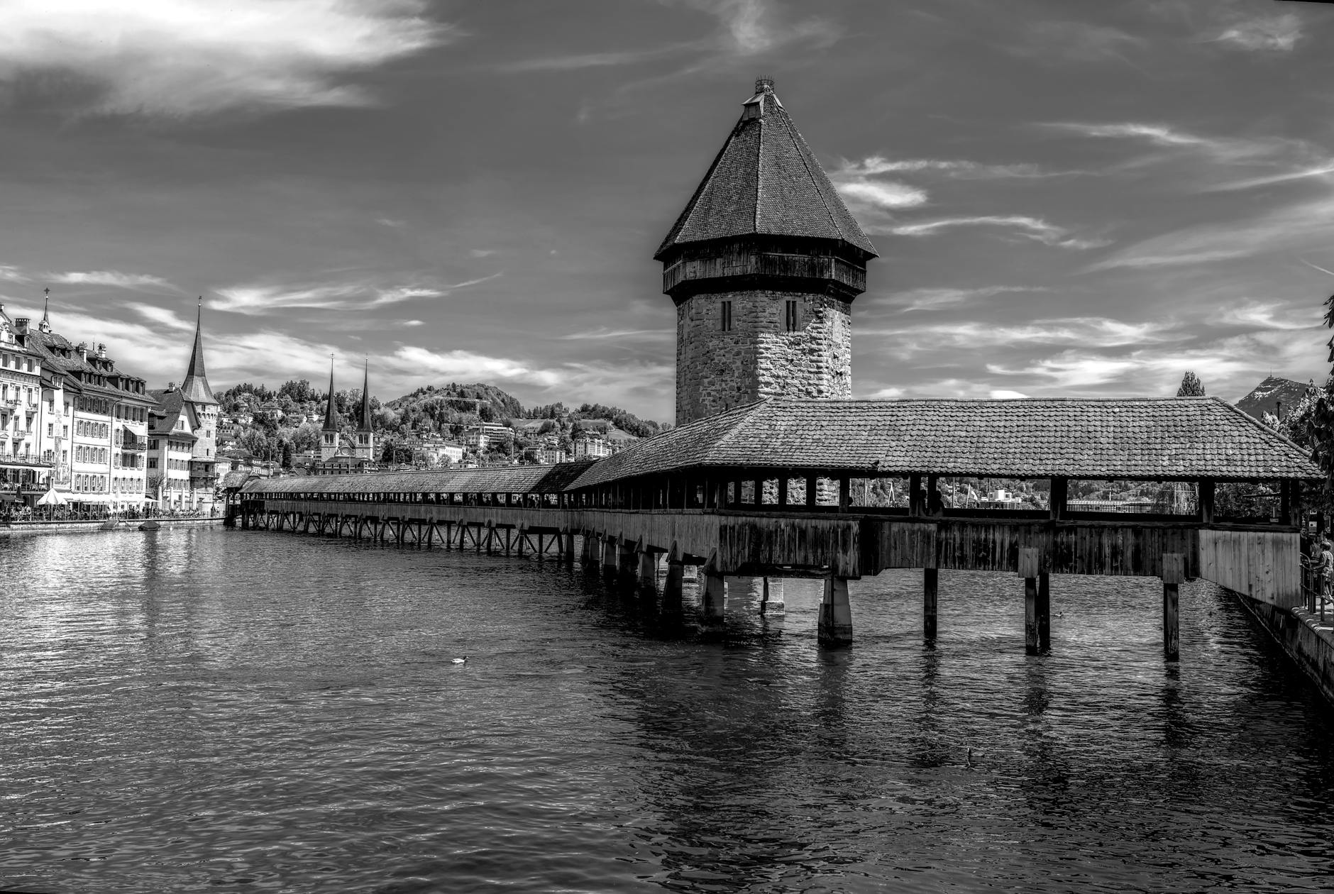 Black and white Chapel Bridge view for conference cost and timing planning.