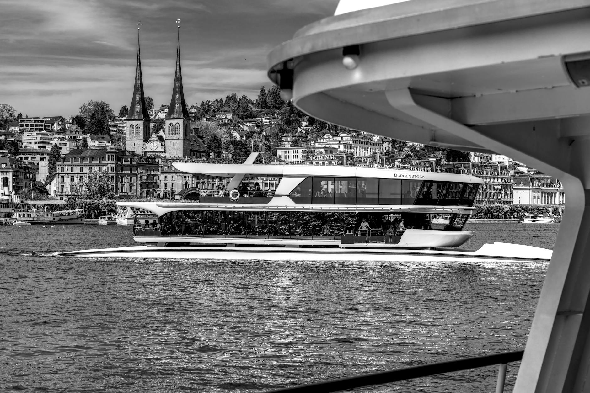 Boat on Lake Lucerne with city towers for consultant travel report planning.