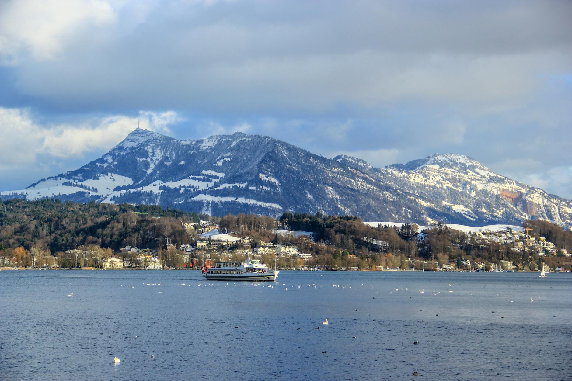 Winter boat and Lake Lucerne mountains for consultant arrival and weather planning.
