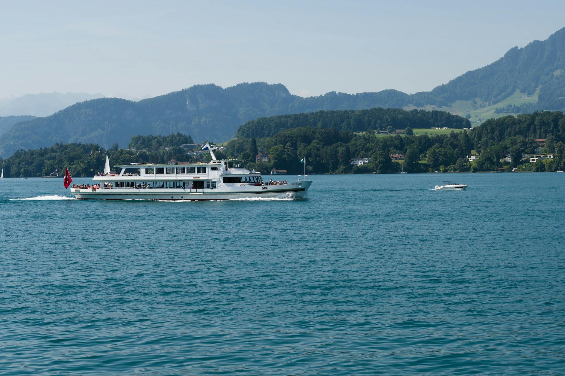 Ferry on Lake Lucerne with mountains for excursion timing decisions.