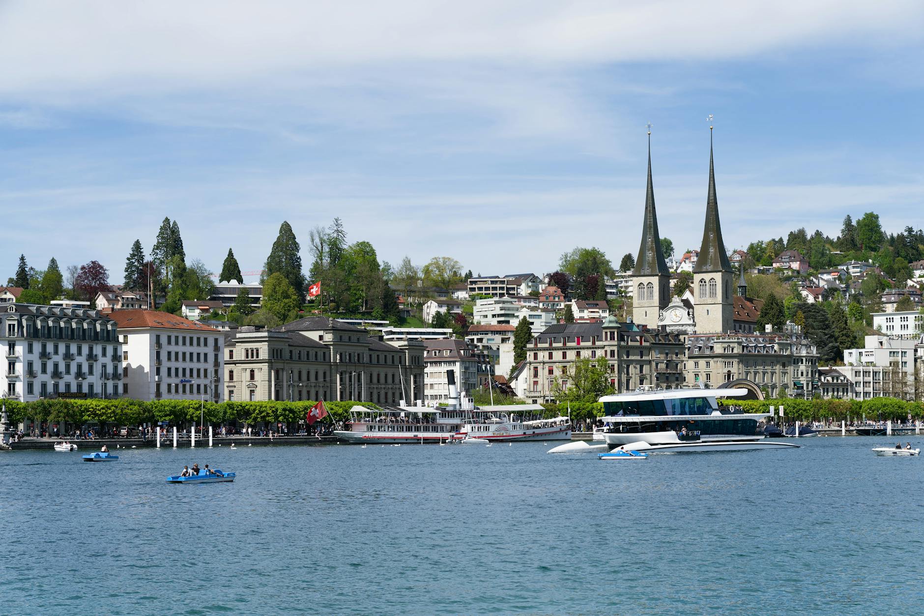 Lucerne waterfront with boats and historic architecture for family route planning.