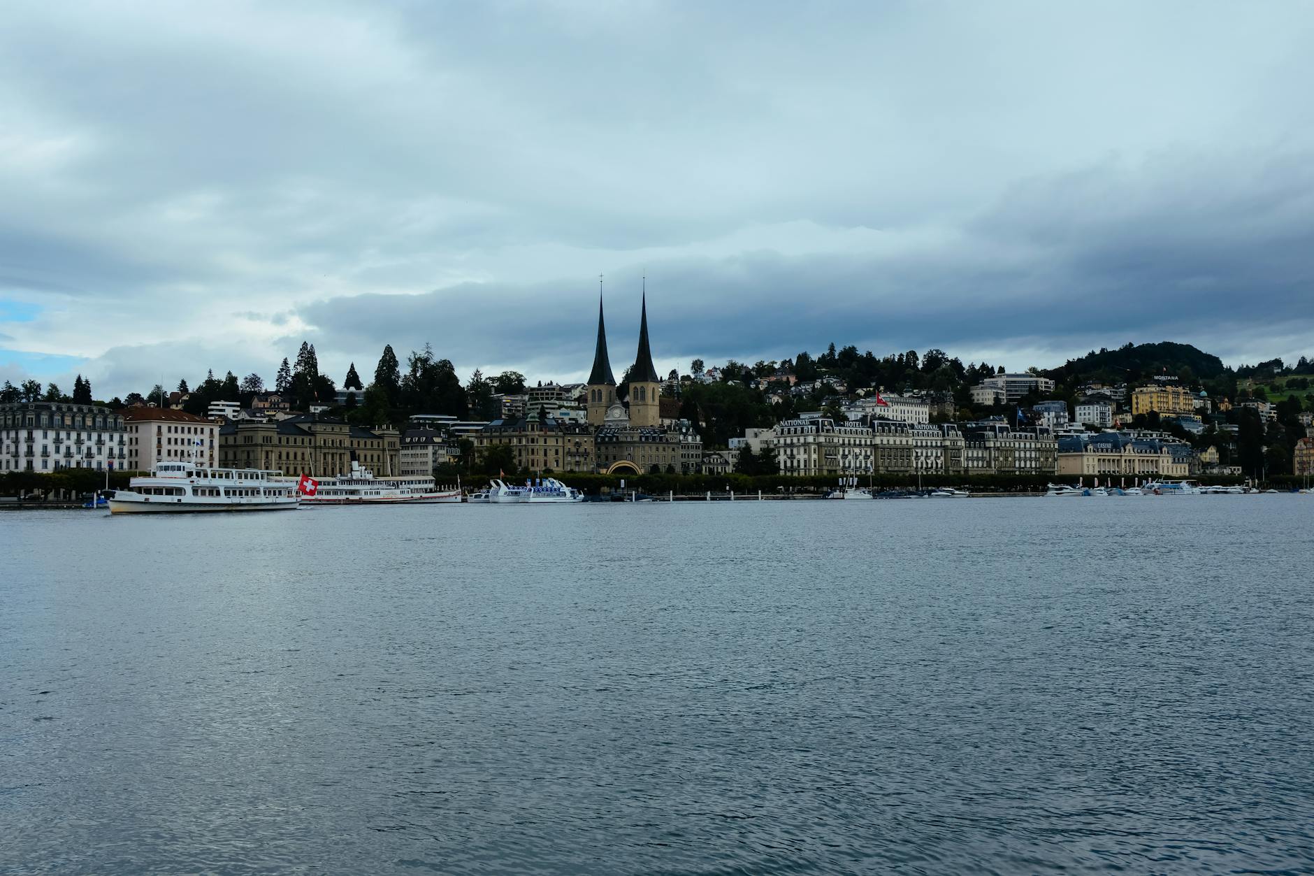 Lucerne waterfront and church towers for investor hotel placement planning.