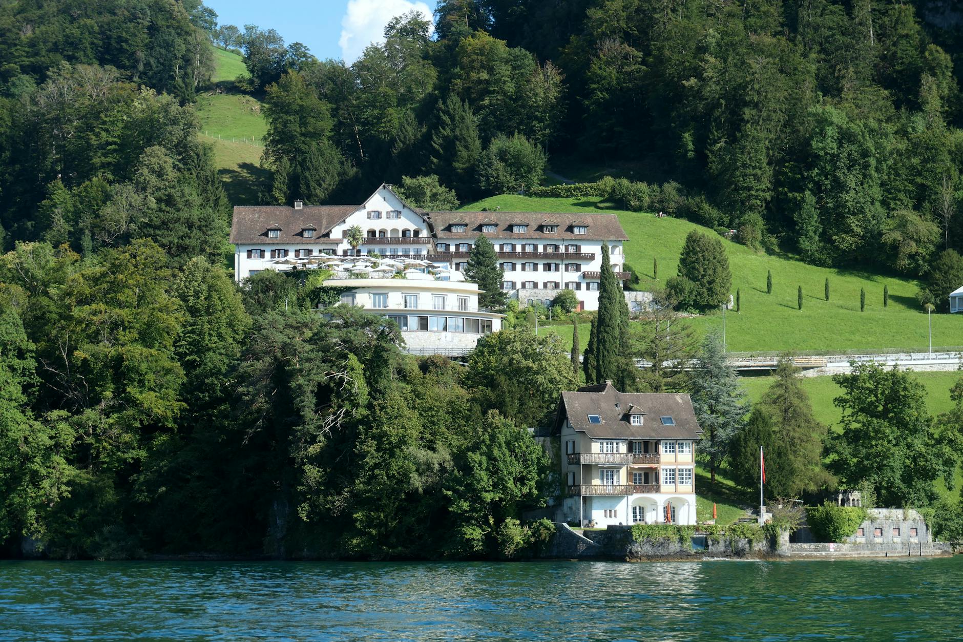 Lake Lucerne mansion and greenery context for luxury hotel selection.