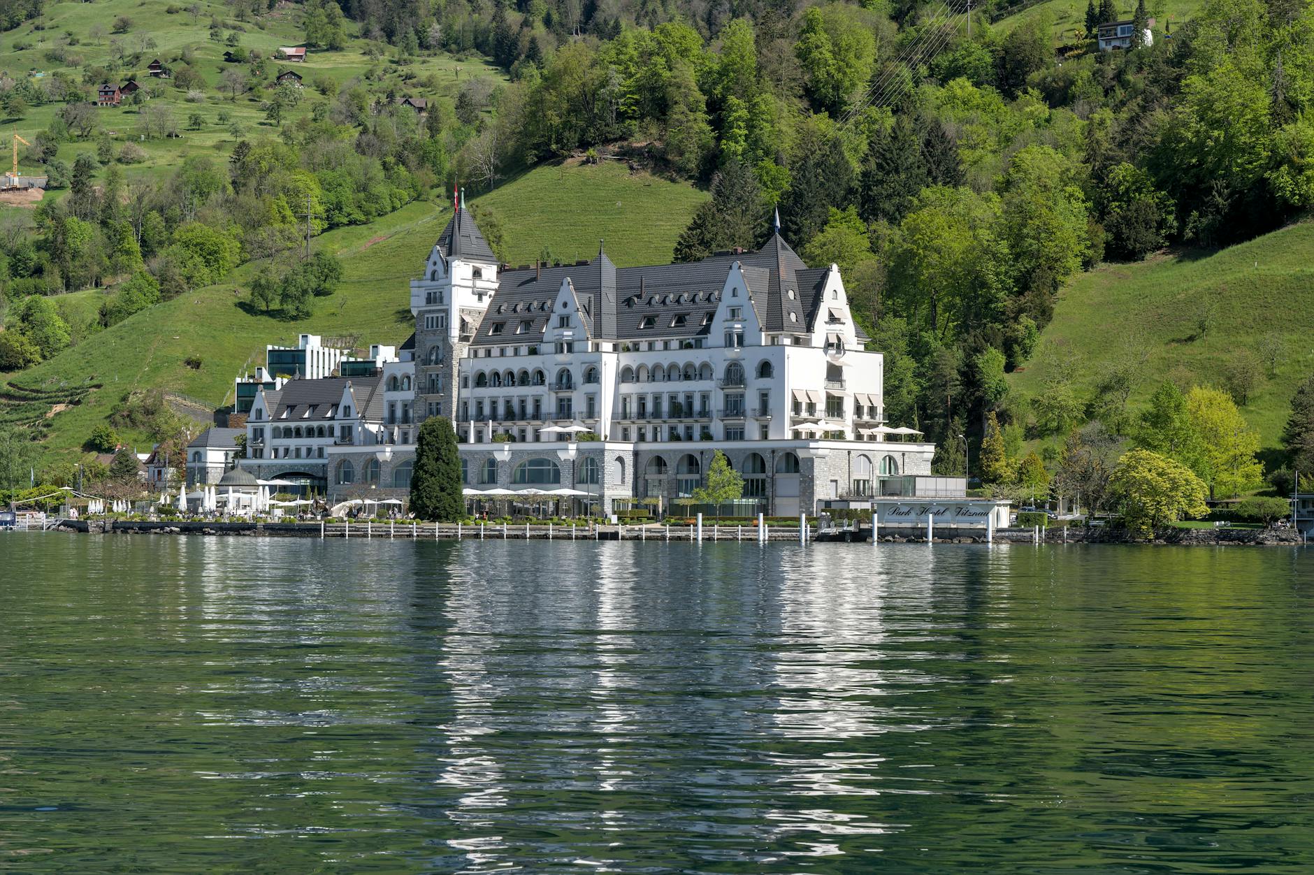 Grand hotel facade on Lake Lucerne for luxury travel report planning.
