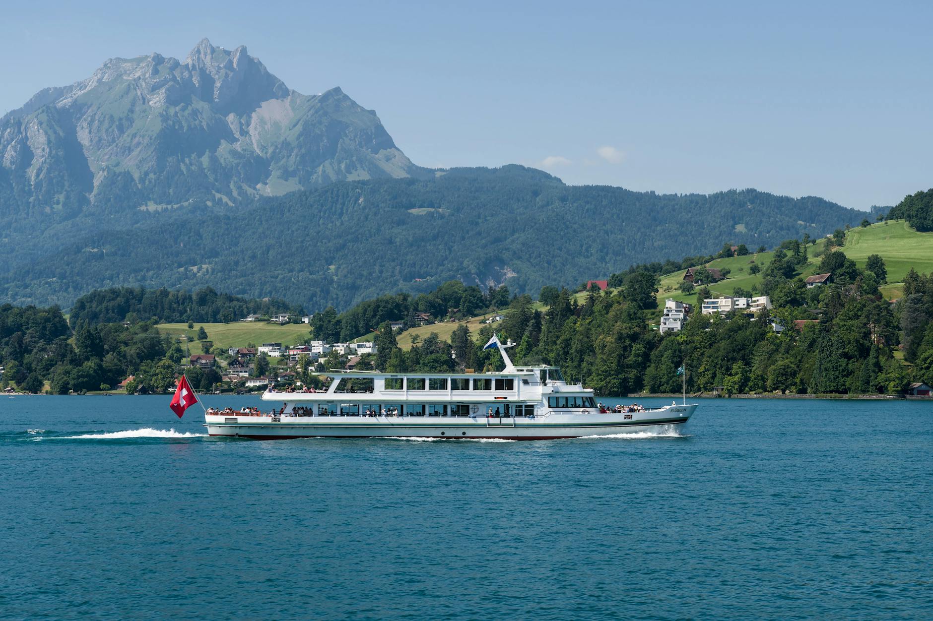 Cruise boat on Lake Lucerne with Mount Pilatus for luxury excursion planning.