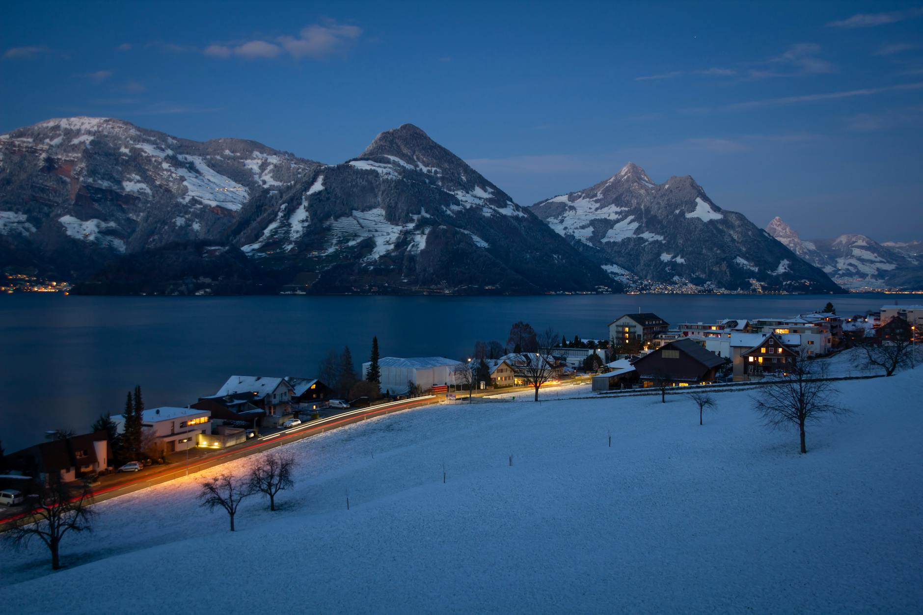 Illuminated Beckenried at dusk for Lucerne nightlife weather planning.