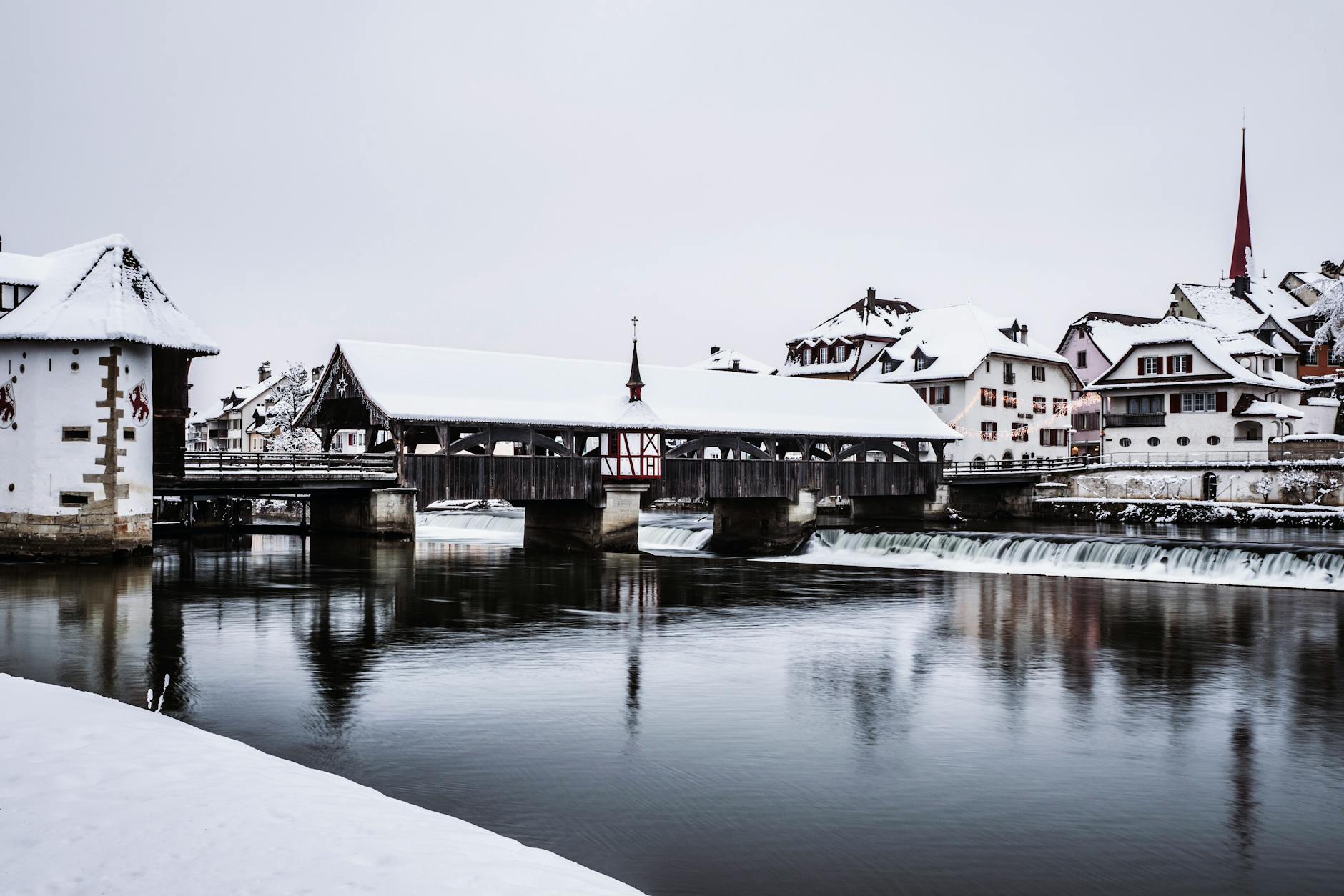 Lucerne buildings and covered bridge reflection for evening district planning.