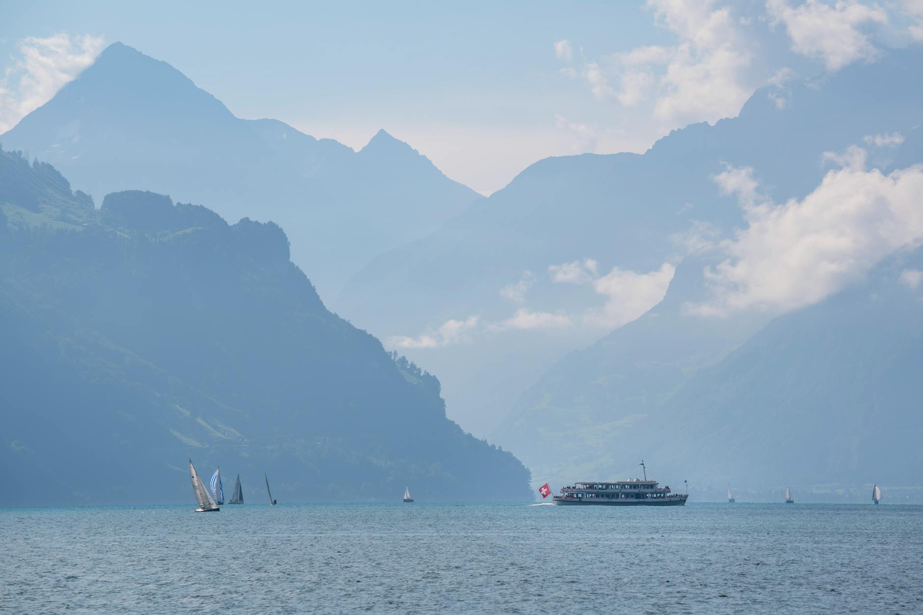 Sailboats and ferry on Lake Lucerne for comfort-minded trip budgeting.