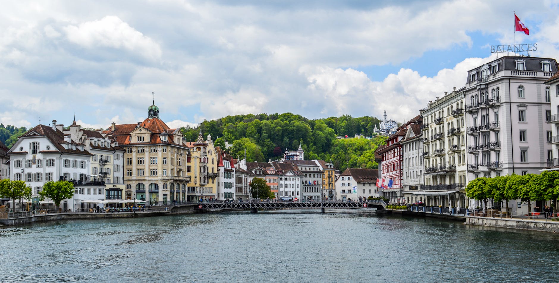 Lucerne riverside buildings and calm water for walking route planning.