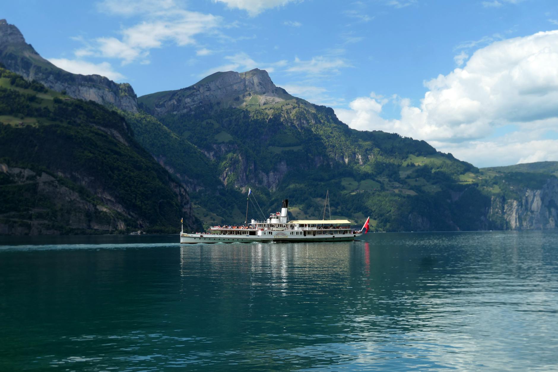 Historic ship on Lake Lucerne with mountains for repeat visitor route planning.