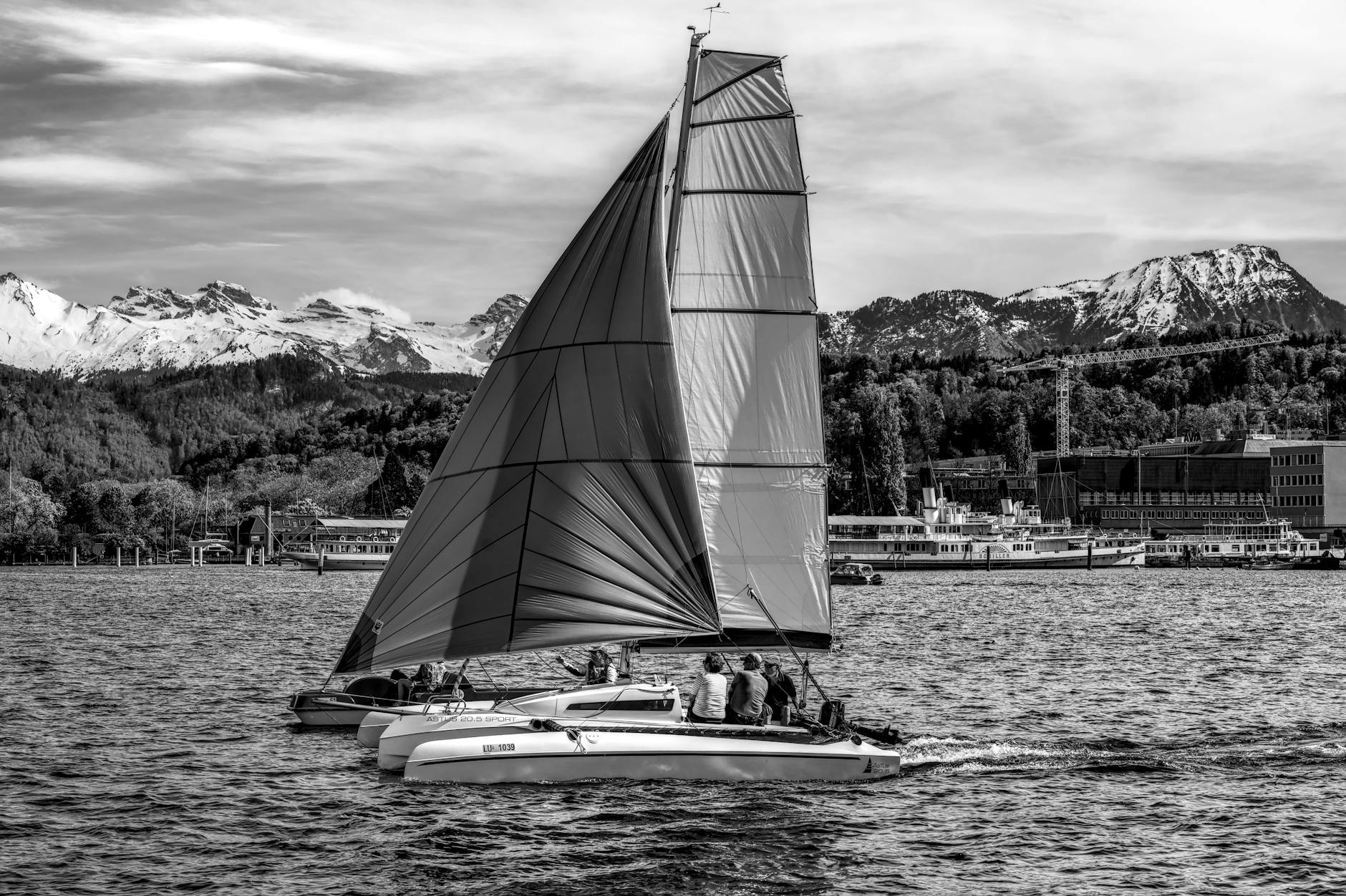 Catamaran on Lake Lucerne with snowy Alps for selective repeat-visit upgrades.
