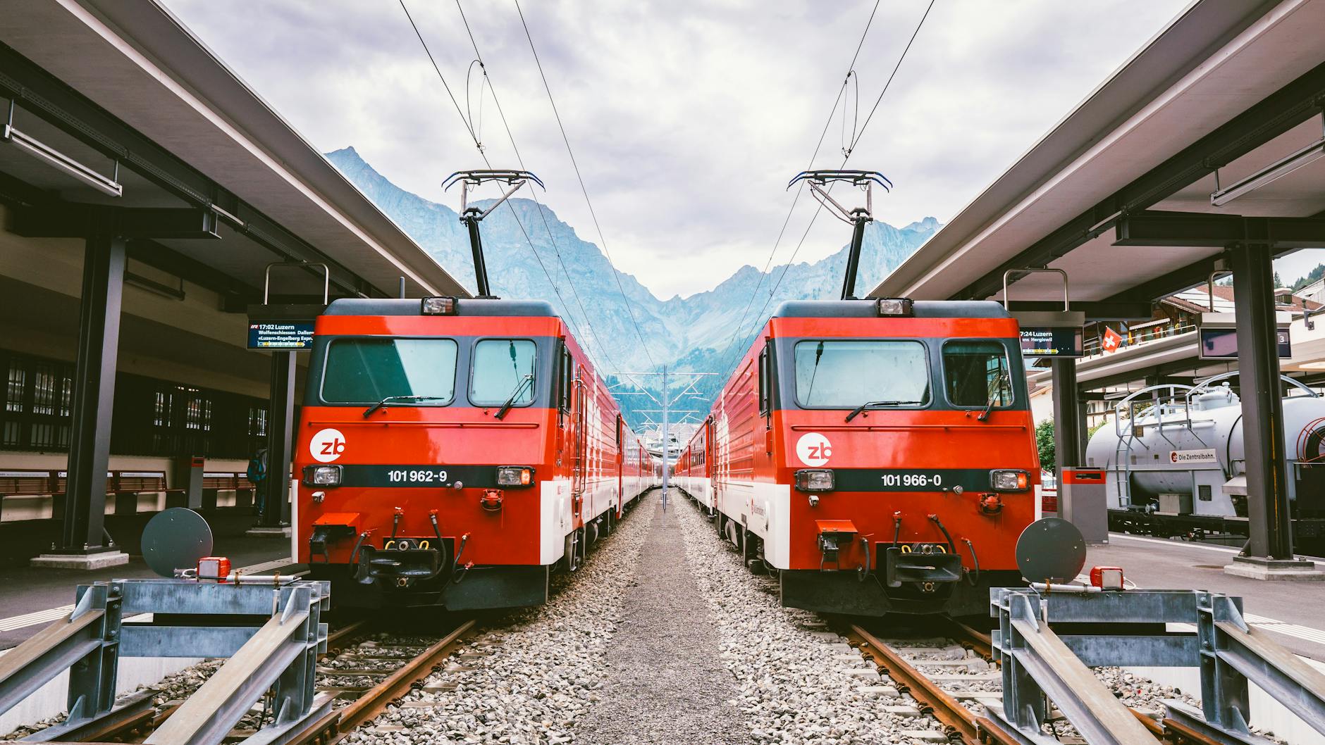 Swiss red trains for Lucerne student rail arrival planning.