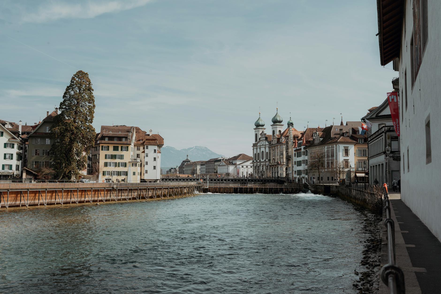 Lucerne riverside buildings and mountains for the central tourist walking loop.