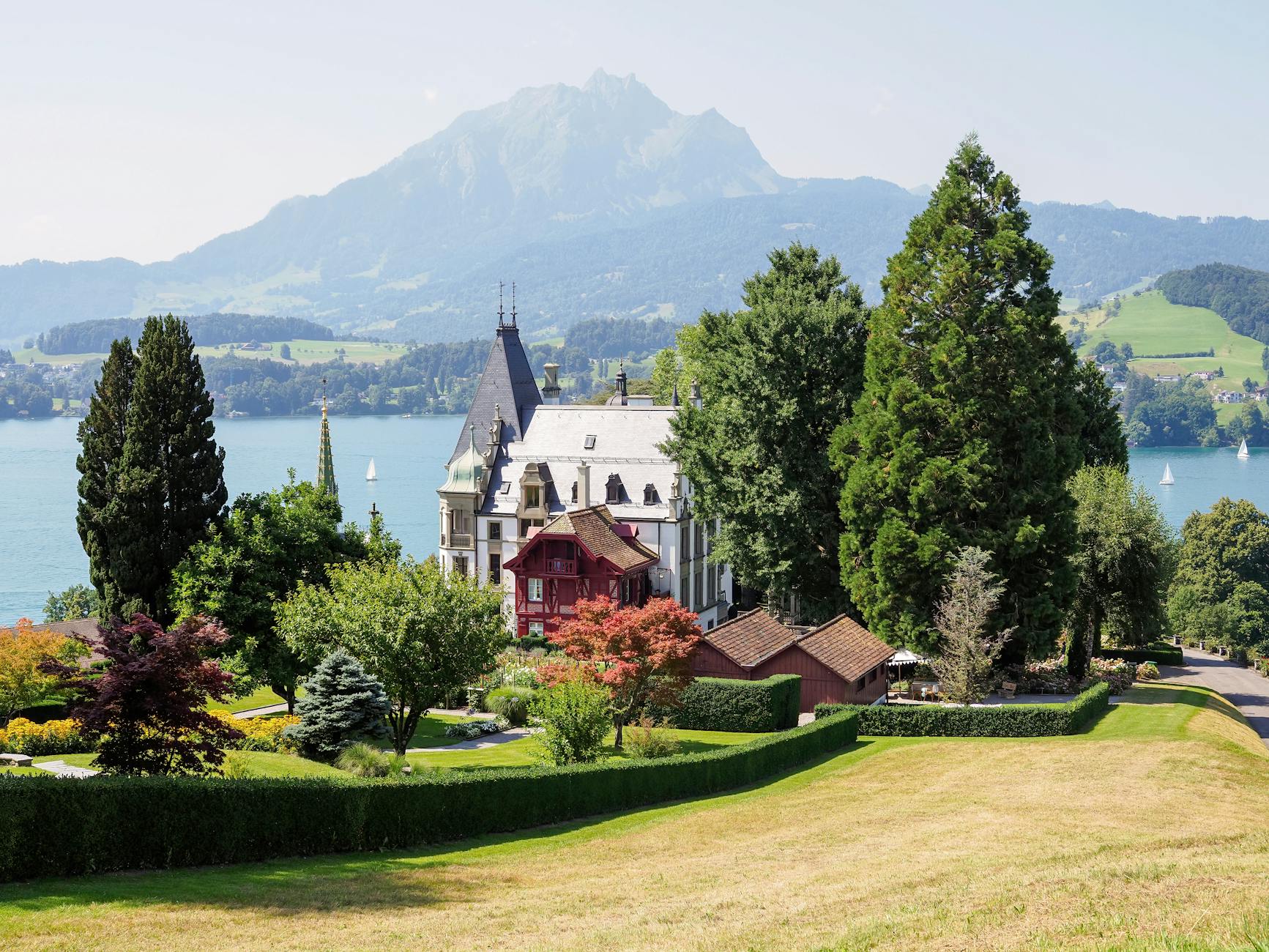 Swiss lakeside castle and mountains for volunteer lodging placement decisions.